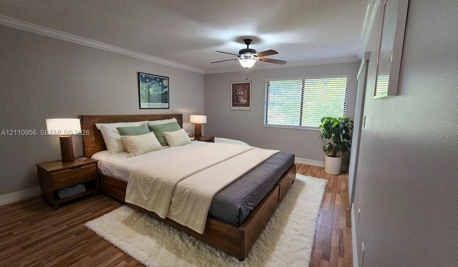 2120 SW 94th Terrace, #404, Davie, FL 33324 Room featuring wood-finish flooring, crown molding, a ceiling fan with integrated lighting, and horizontal window blinds