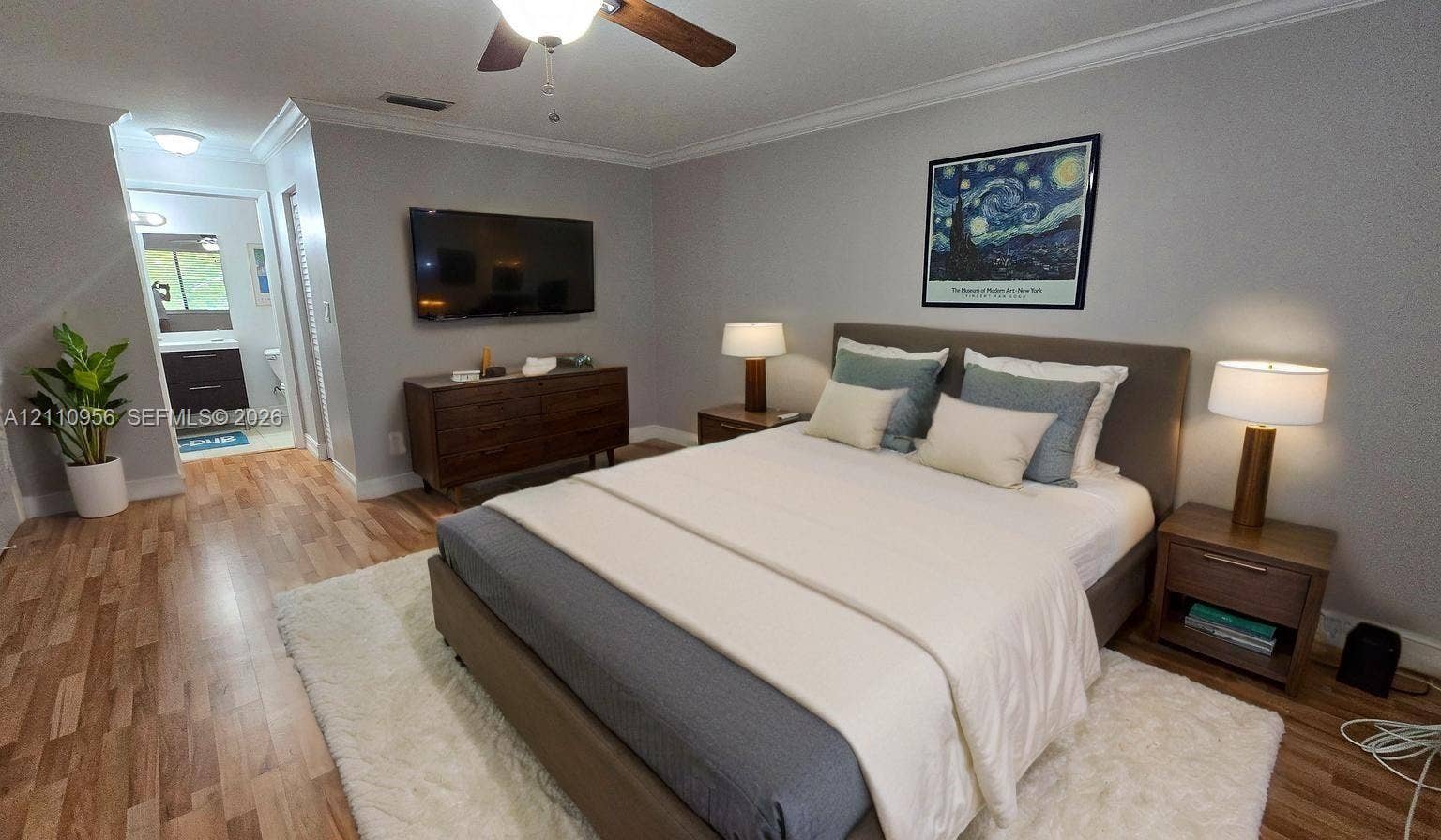 2120 SW 94th Terrace, #404, Davie, FL 33324 Virtual Bedroom featuring wood-finish flooring, crown molding, and a ceiling fan with integrated lighting