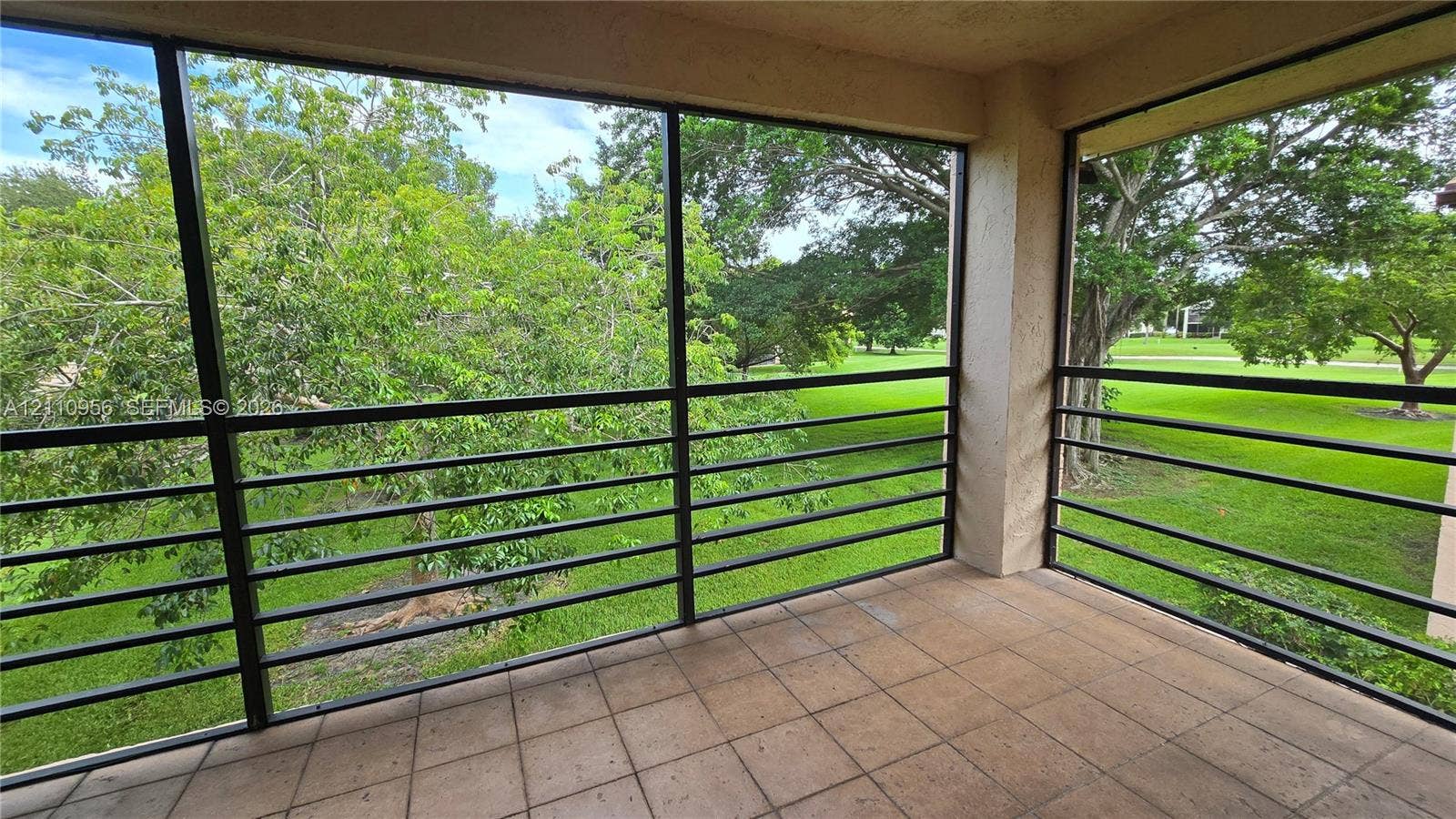 2120 SW 94th Terrace, #404, Davie, FL 33324 Screened-in balcony featuring tile flooring and metal railing