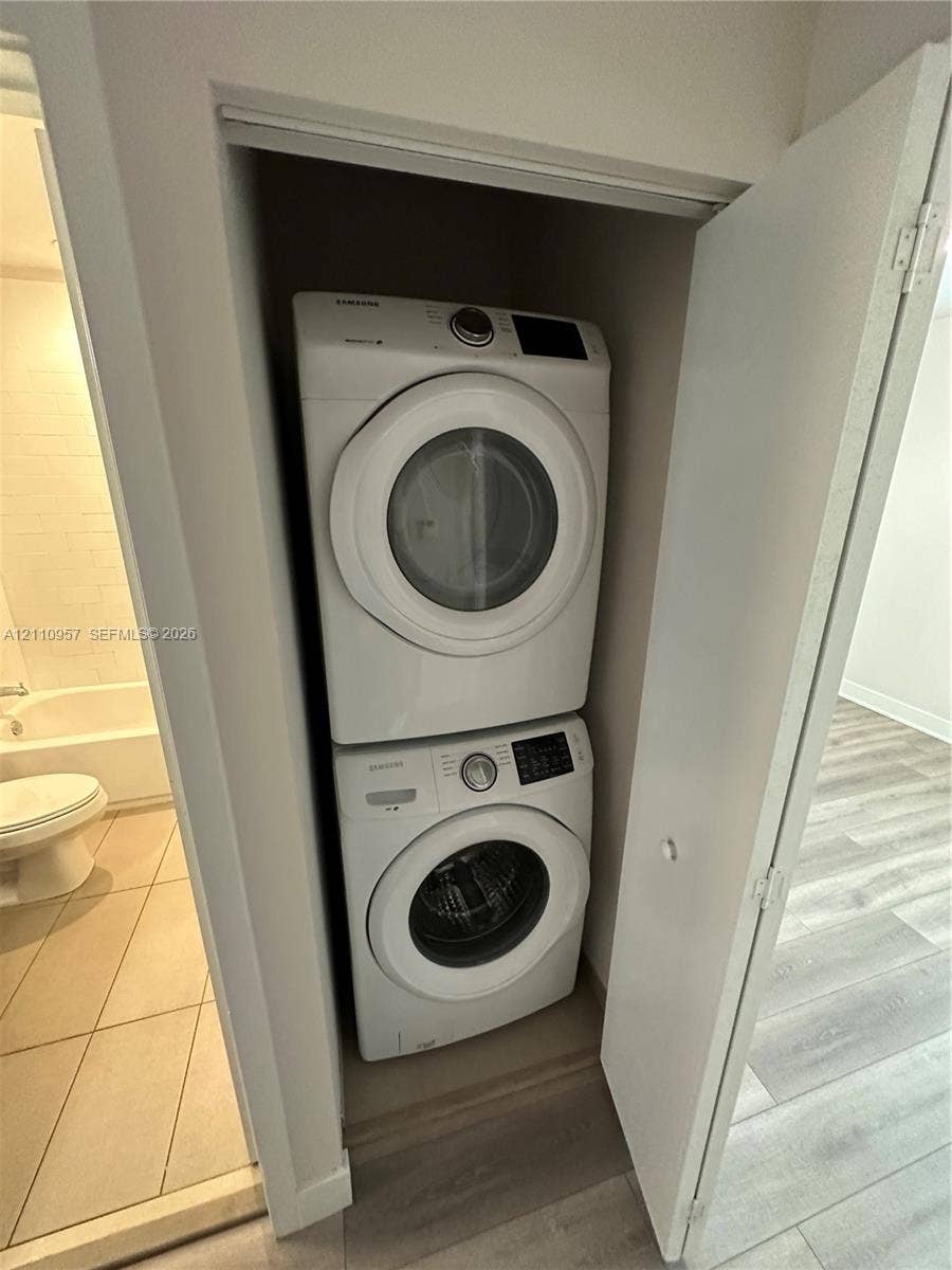 12115 NE 5th Avenue, #12115, North Miami, North Miami, FL 33161 Built-in laundry closet featuring a stacked white front-load washer and dryer