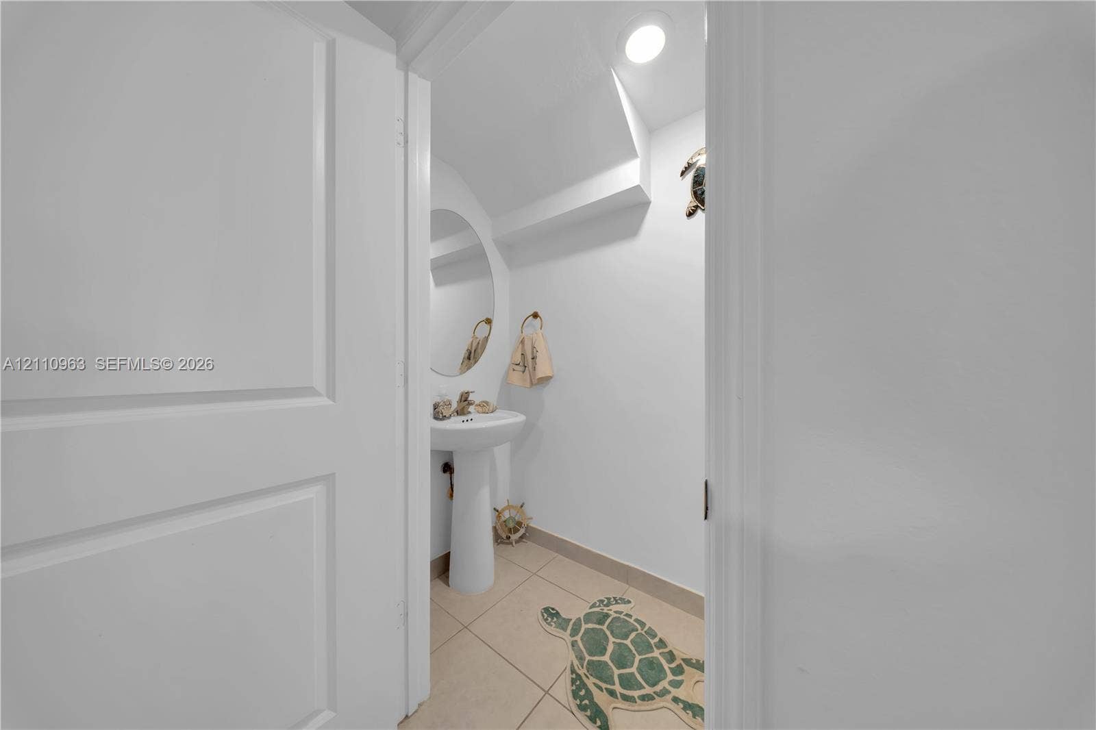 23436 SW 129th Avenue, #23436, Homestead, Homestead, FL 33032 White pedestal sink with a metallic faucet, oval wall mirror, recessed ceiling lighting, and tile flooring