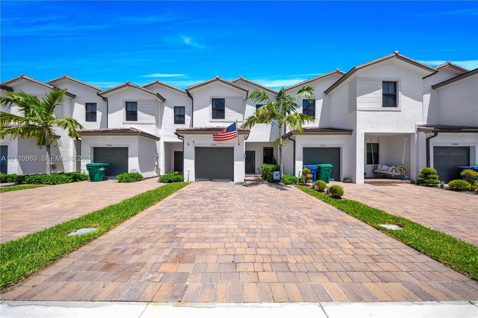 23436 SW 129th Avenue, #23436, Homestead, Homestead, FL 33032 Stucco exterior featuring multi-unit architectural design, paved stone driveways, attached garage bays, and landscaping
