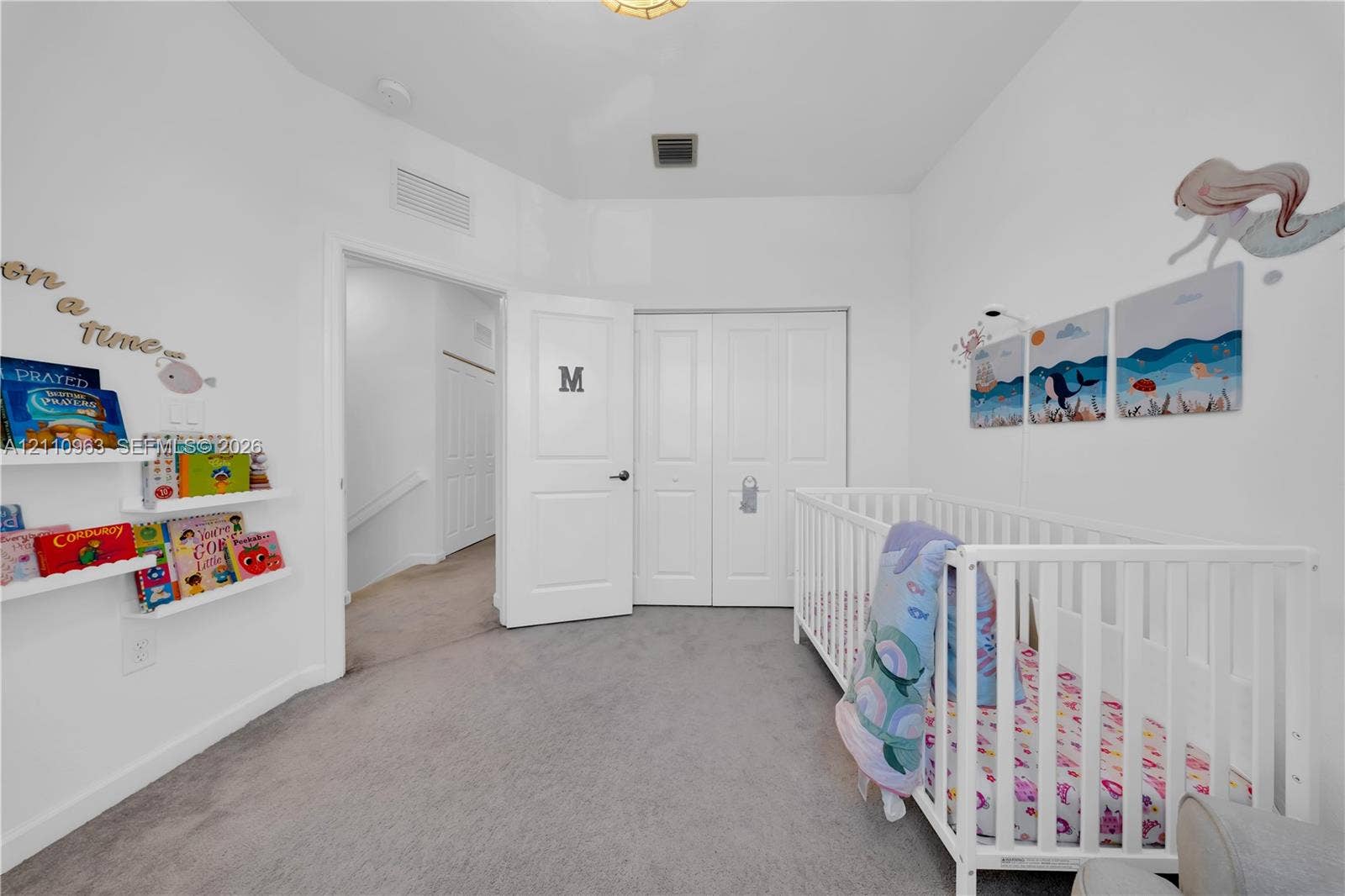23436 SW 129th Avenue, #23436, Homestead, Homestead, FL 33032 Interior room featuring wall-to-wall carpeting, white two-panel interior doors, built-in floating wall shelving, and a double-door closet