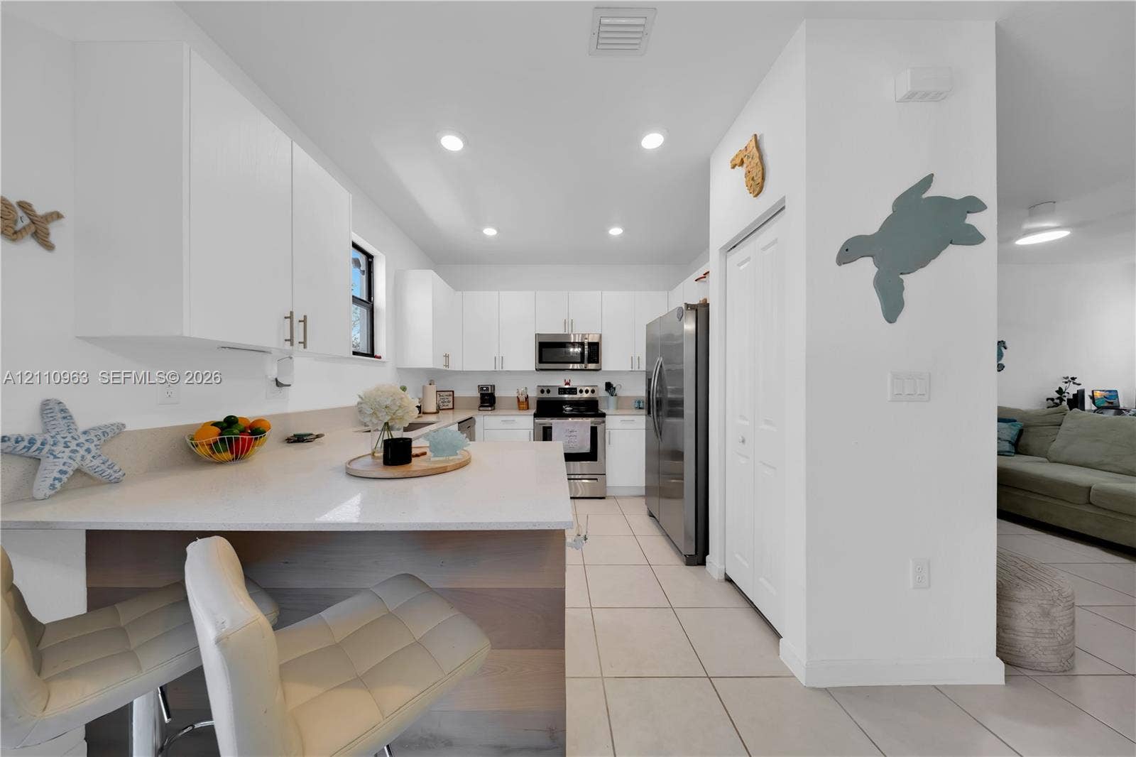 23436 SW 129th Avenue, #23436, Homestead, Homestead, FL 33032 Kitchen featuring white cabinetry, quartz countertops, a stone-finish waterfall edge island, recessed lighting, and stainless steel appliances