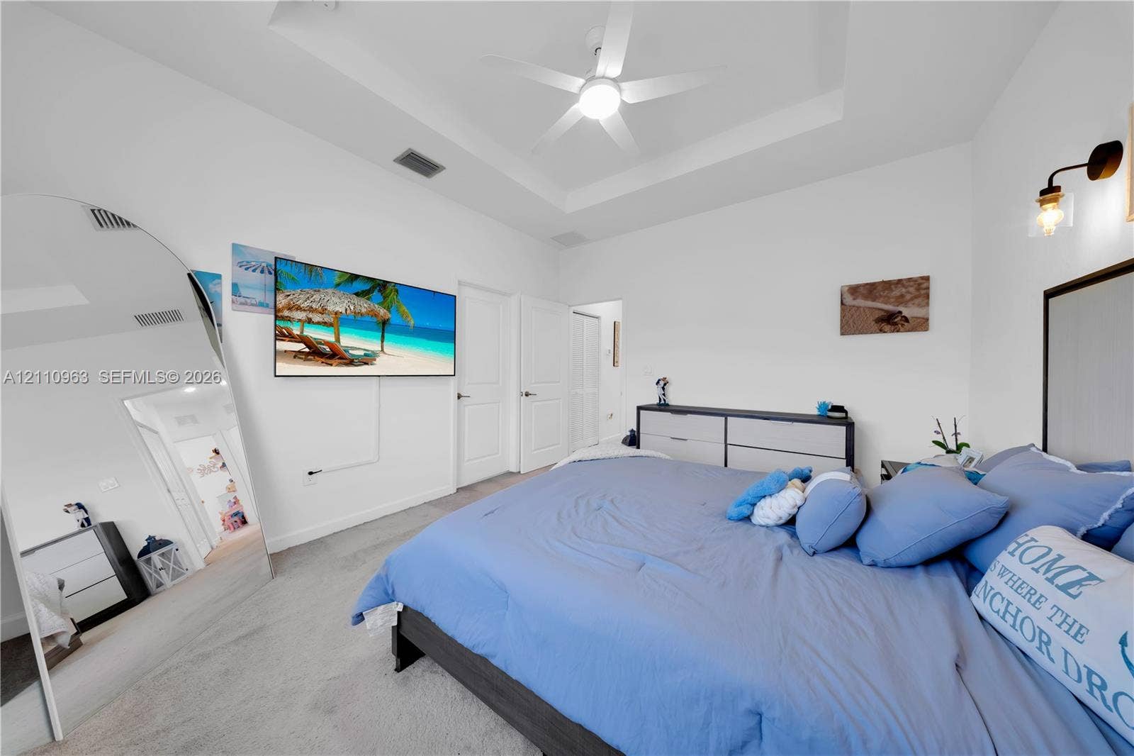 23436 SW 129th Avenue, #23436, Homestead, Homestead, FL 33032 Bedroom featuring a tray ceiling, ceiling fan with integrated lighting, wall-mounted light fixture, and solid-core interior doors