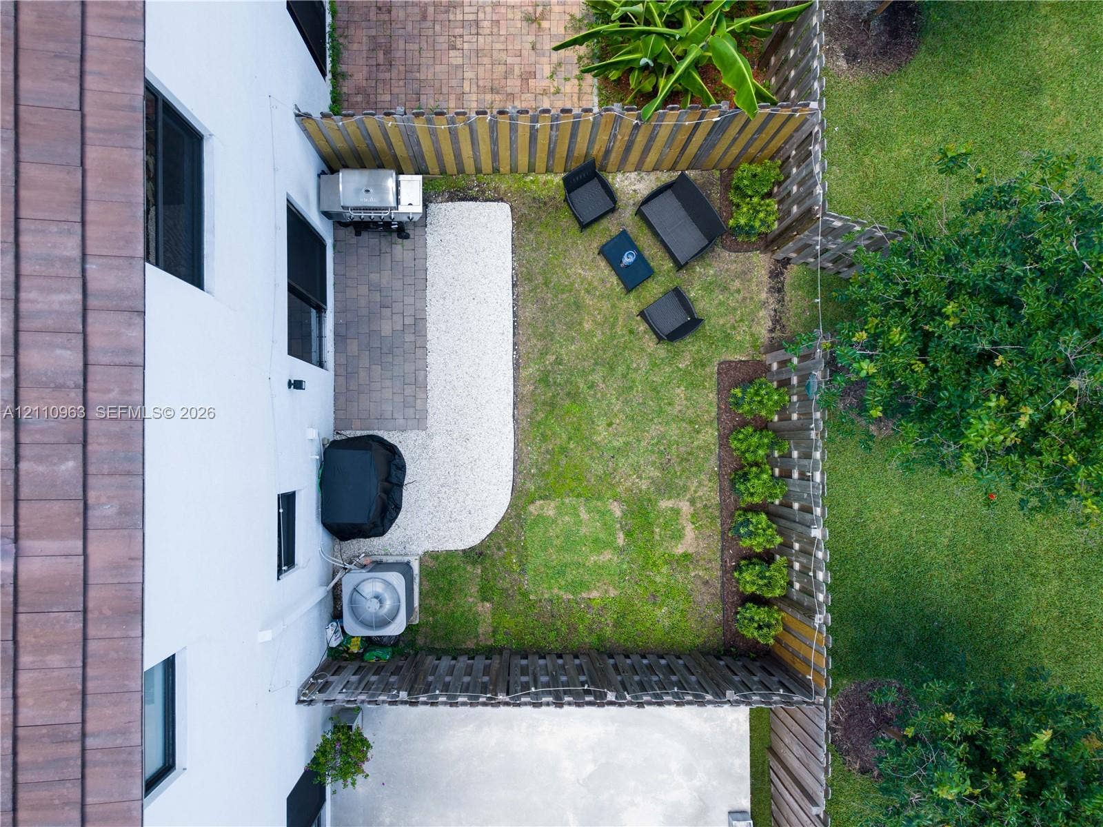 23436 SW 129th Avenue, #23436, Homestead, Homestead, FL 33032 Fenced outdoor area featuring paver patio, gravel ground cover, and structured landscaping
