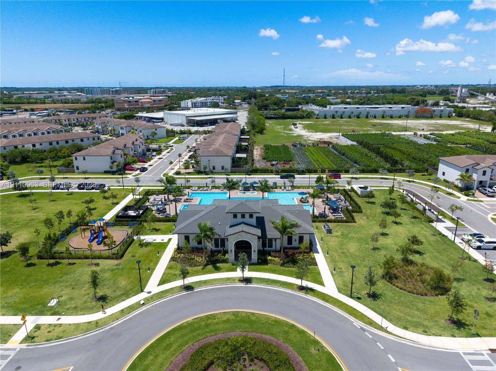 23436 SW 129th Avenue, #23436, Homestead, Homestead, FL 33032 Community clubhouse featuring a swimming pool, surrounding sun deck, and a dedicated playground area situated within landscaped grounds