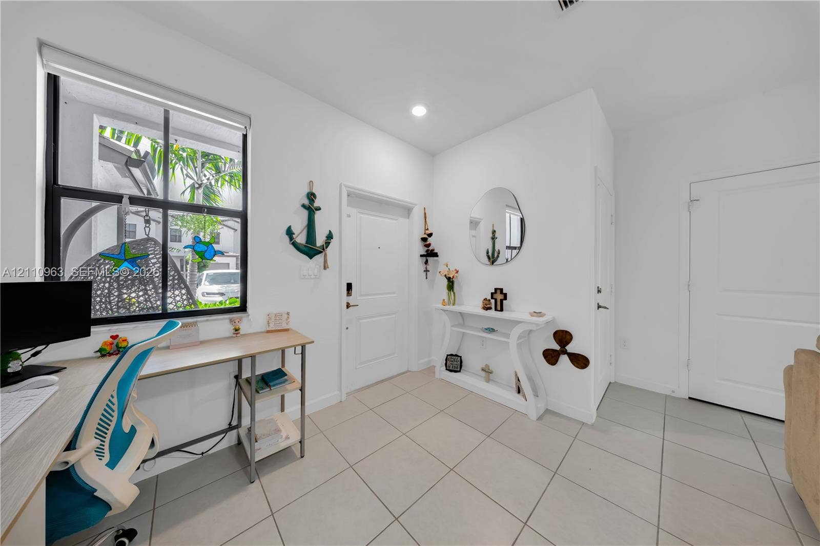 23436 SW 129th Avenue, #23436, Homestead, Homestead, FL 33032 Neutral tile flooring, large multi-pane window, recessed lighting, and white interior doors