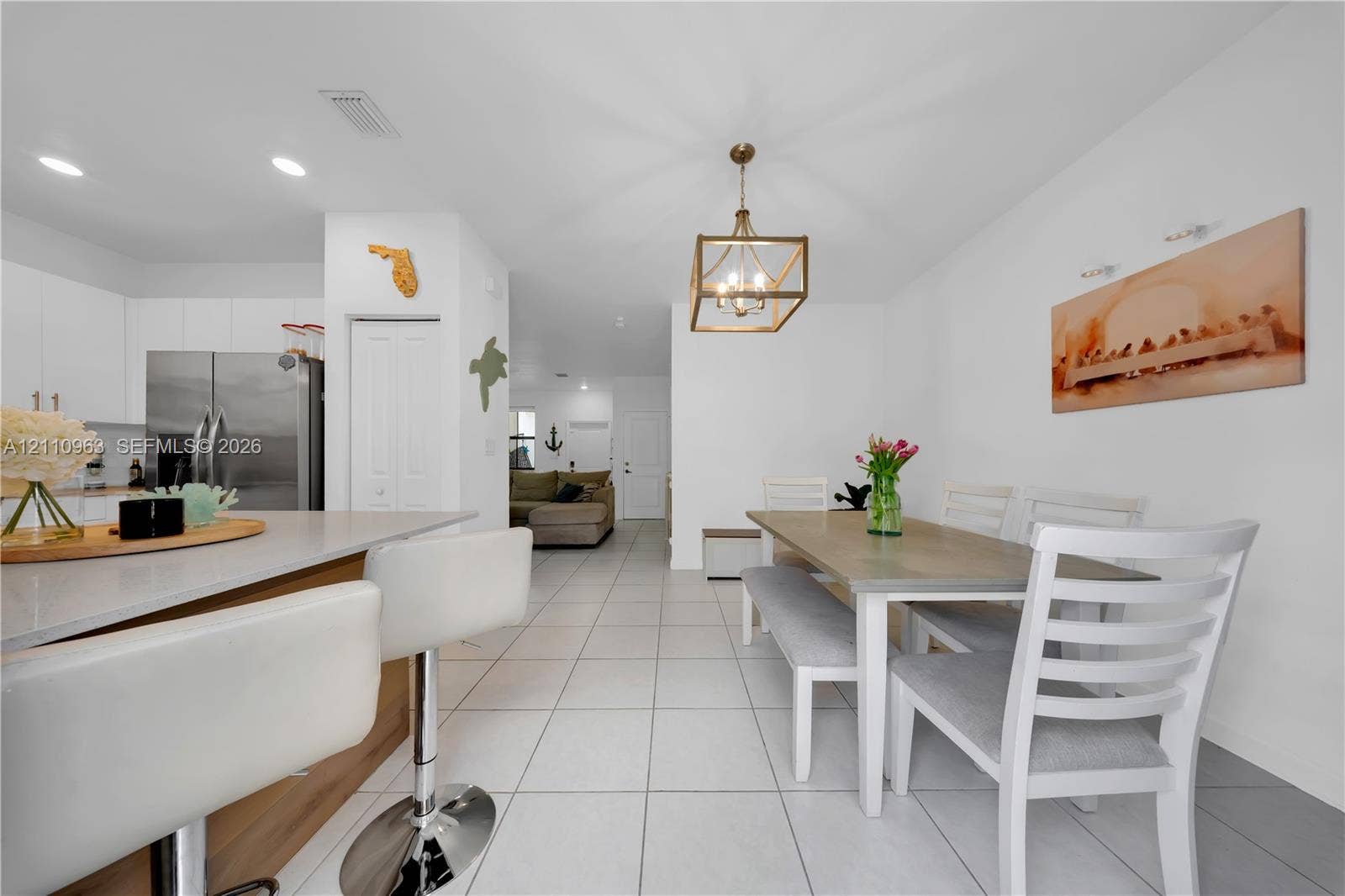 23436 SW 129th Avenue, #23436, Homestead, Homestead, FL 33032 Kitchen featuring a peninsula with stone-look countertops, stainless steel refrigerator, recessed lighting, and a geometric pendant light fixture, complemented by light-toned tile flooring