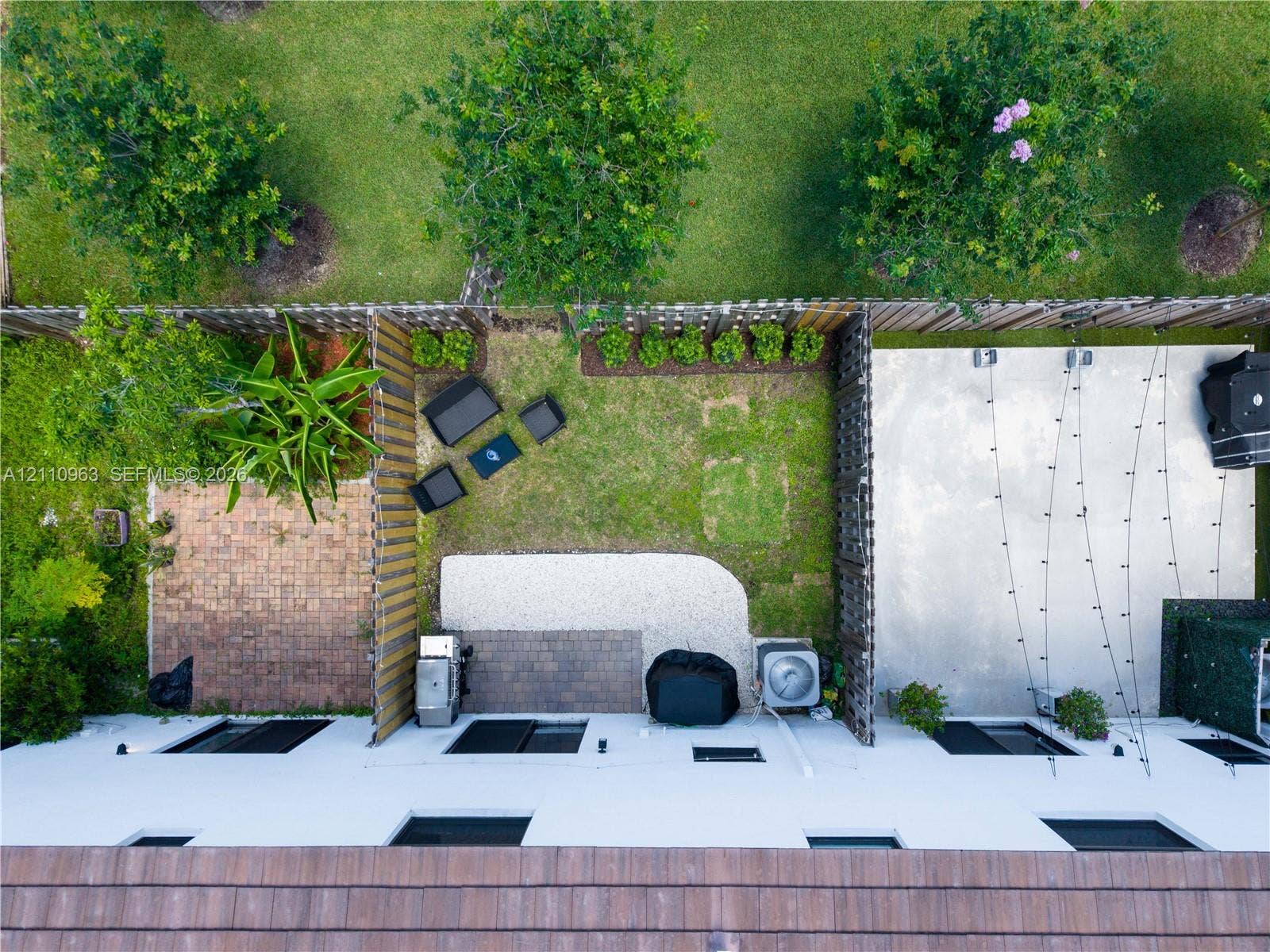 23436 SW 129th Avenue, #23436, Homestead, Homestead, FL 33032 Rear outdoor space featuring a paved patio, gravel ground cover, manicured lawn, and privacy fencing