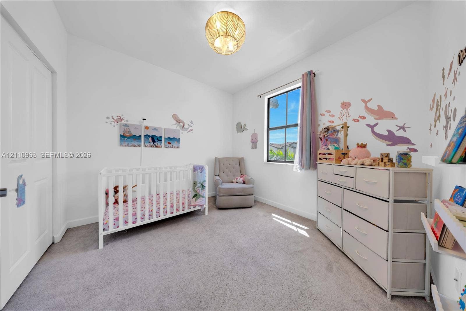 23436 SW 129th Avenue, #23436, Homestead, Homestead, FL 33032 Neutral-toned carpeting, single-hung window with dark framing, and a central spherical light fixture with a metallic finish