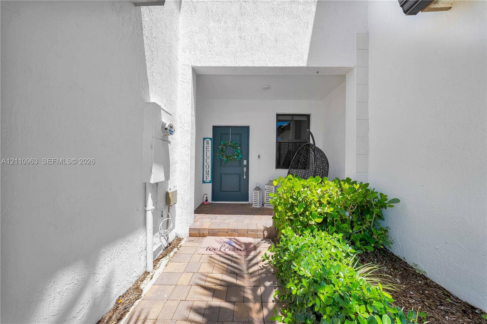 23436 SW 129th Avenue, #23436, Homestead, Homestead, FL 33032 Recessed entryway featuring stucco exterior walls, paved brick walkway, and a paneled entry door