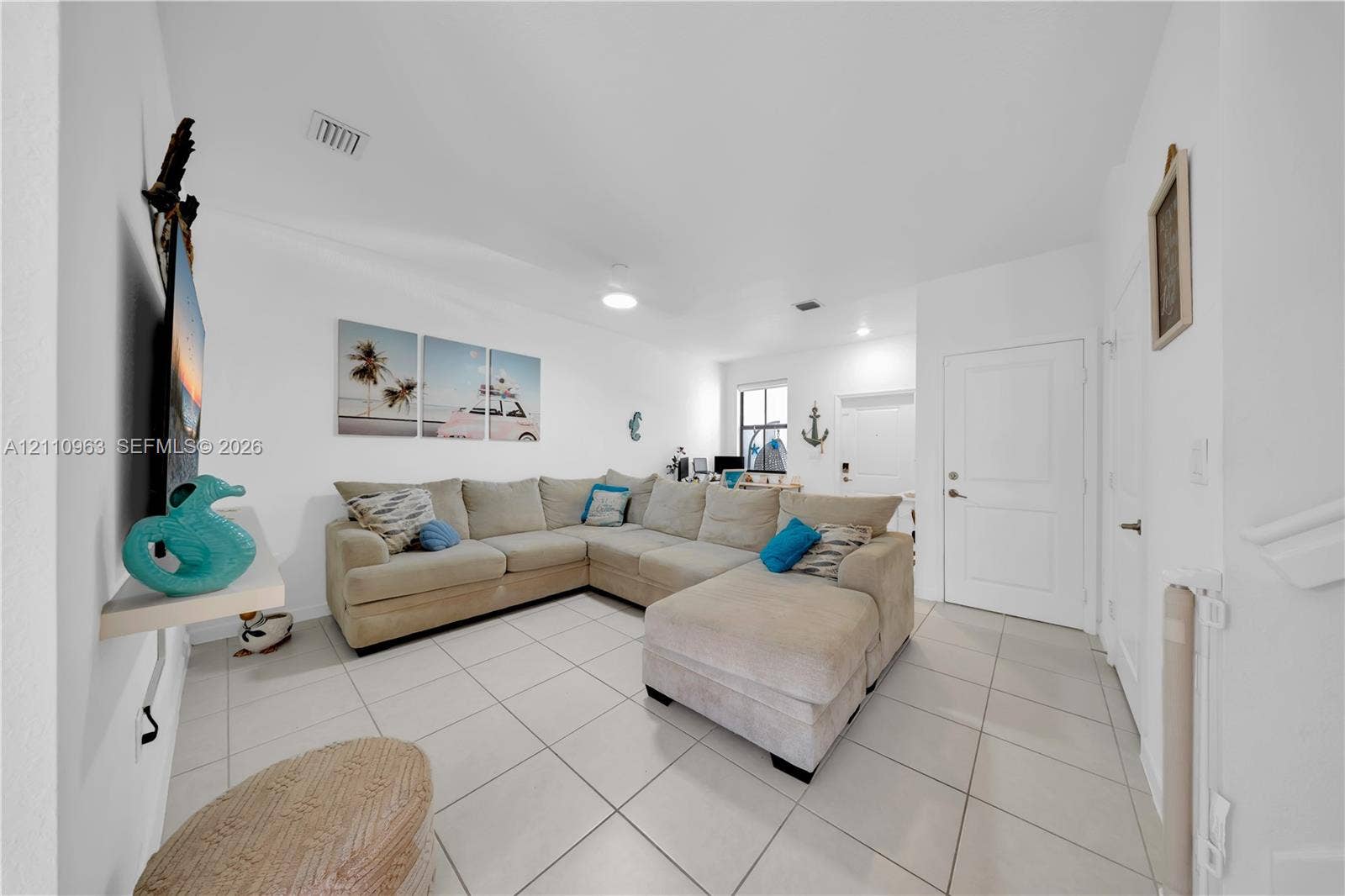 23436 SW 129th Avenue, #23436, Homestead, Homestead, FL 33032 Open-concept interior featuring light-colored floor tiling, neutral wall finishes, recessed lighting, and a multi-panel door