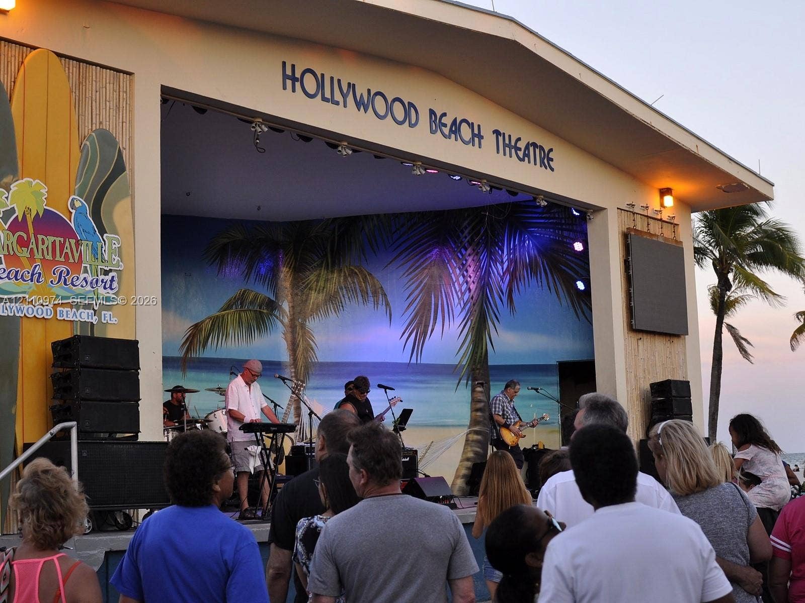 2030 S Ocean Drive, #803, Hallandale Beach, FL 33009 Outdoor entertainment venue featuring a covered stage, integrated sound system, bamboo-paneled siding, and a mural backdrop