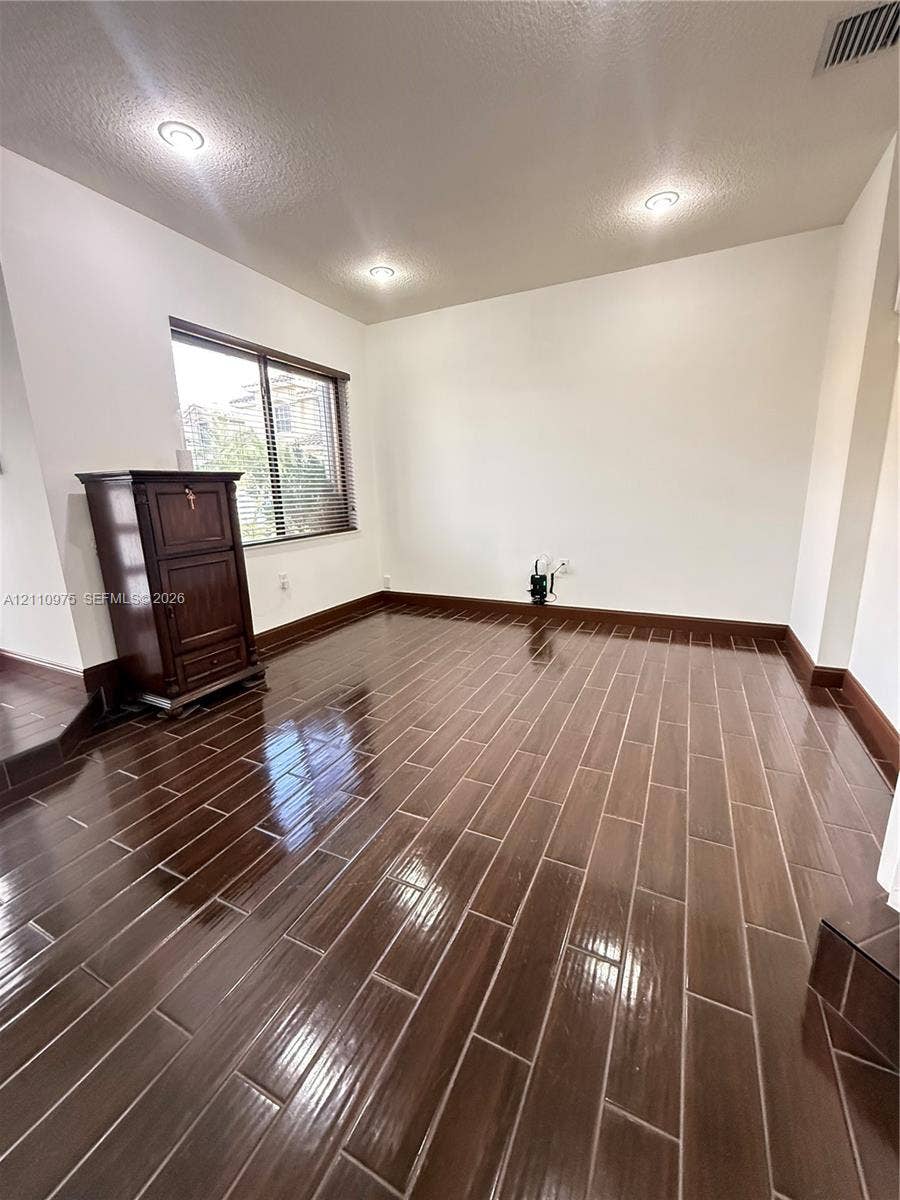 2030 NW 99th Terrace, Pembroke Pines, FL 33024 Glossy wood-finish tile flooring, recessed ceiling lighting, and a window with horizontal blinds
