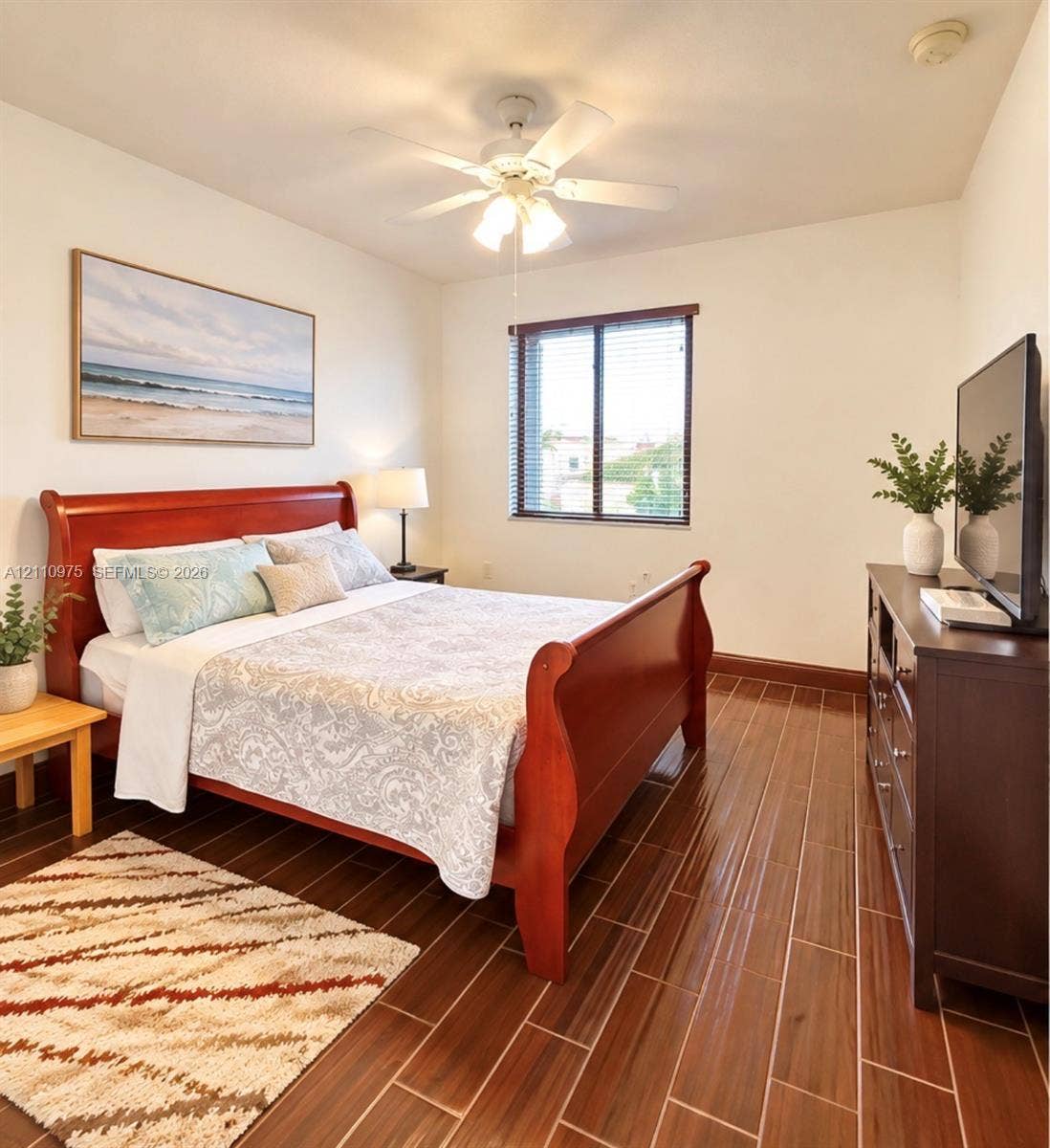 2030 NW 99th Terrace, Pembroke Pines, FL 33024 Room featuring wood-finish tile flooring, ceiling fan with light fixture, and horizontal blinds