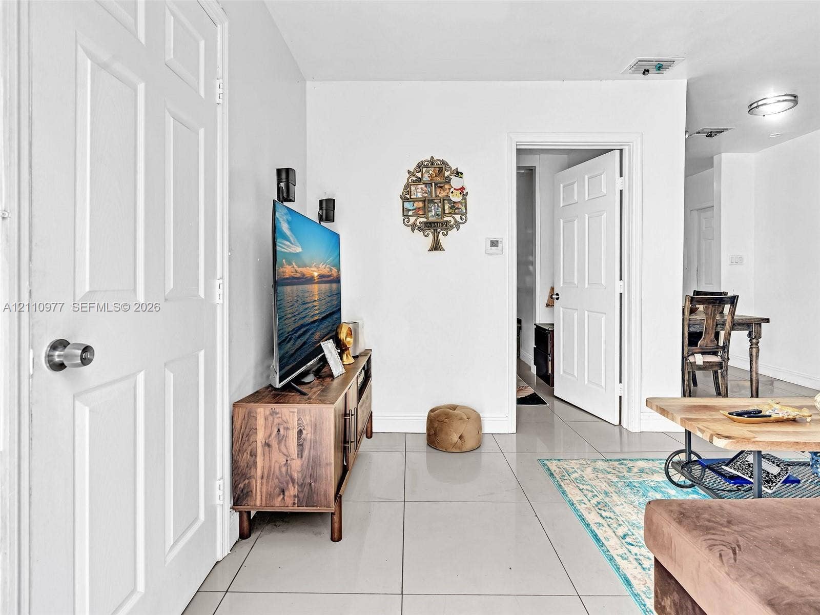 2126 Cleveland Street, #2126, Hollywood, Hollywood, FL 33020 Interior space featuring large-format ceramic tile flooring, neutral wall finishes, and solid-core six-panel interior doors with brushed metal hardware