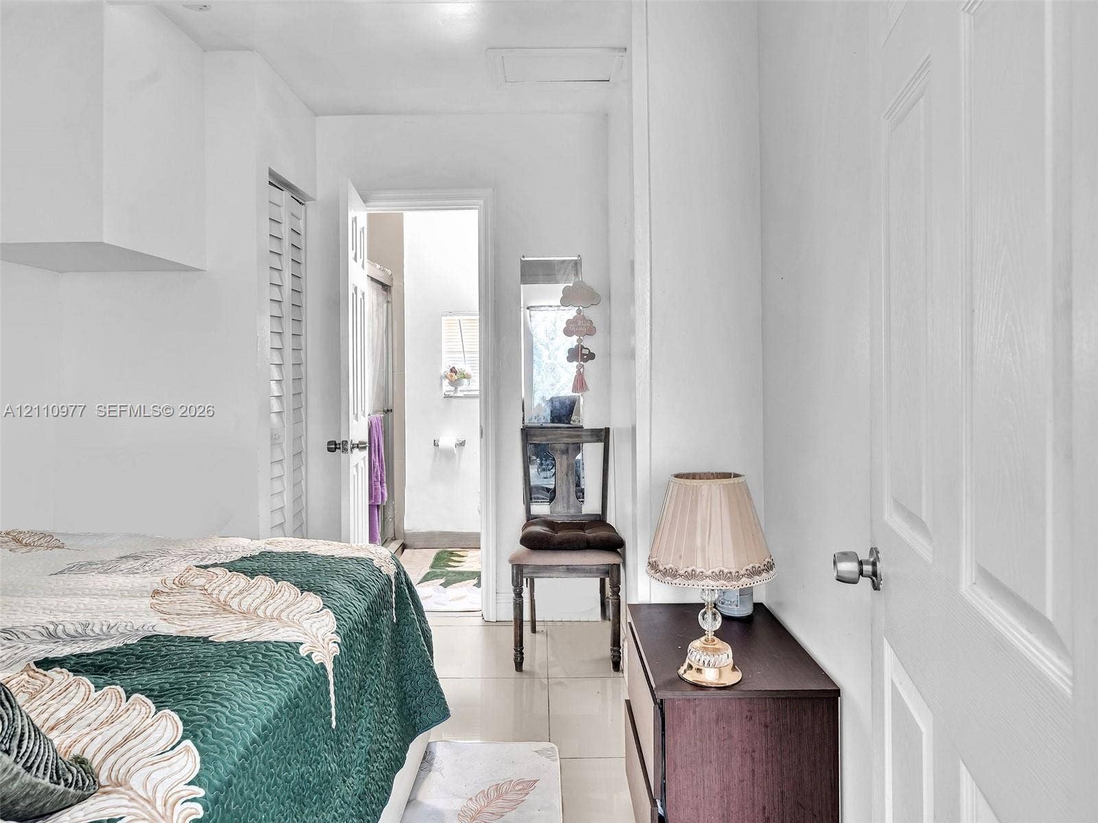 2126 Cleveland Street, #2126, Hollywood, Hollywood, FL 33020 Neutral-toned tile flooring, louvered closet doors, and a six-panel interior door
