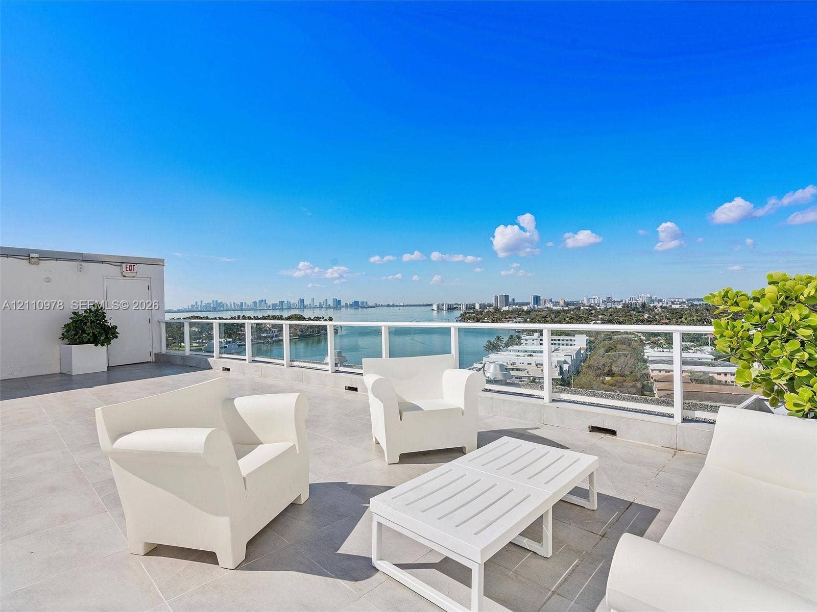 900 Bay Drive, #225, Miami Beach, FL 33141 Expansive rooftop terrace featuring large-format tile flooring and a white powder-coated railing