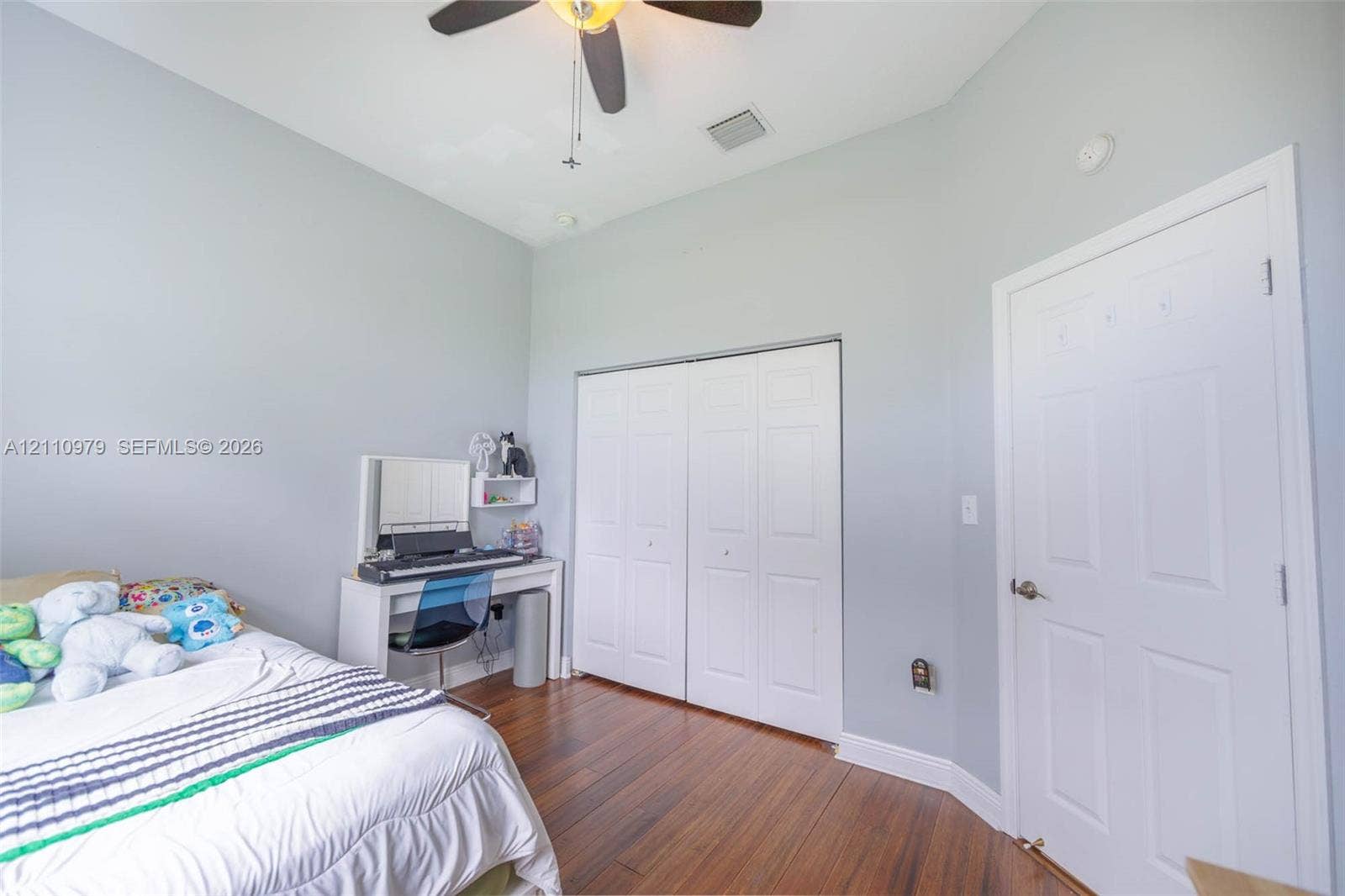 Vaulted ceilings, wood-finish flooring, and a ceiling fan with integrated lighting