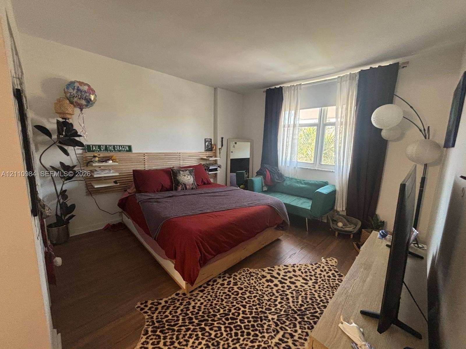 3745 NE 171st Street, #77, North Miami Beach, North Miami Beach, FL 33160 Wood-finish flooring, horizontal slat wall feature, and large window with natural light