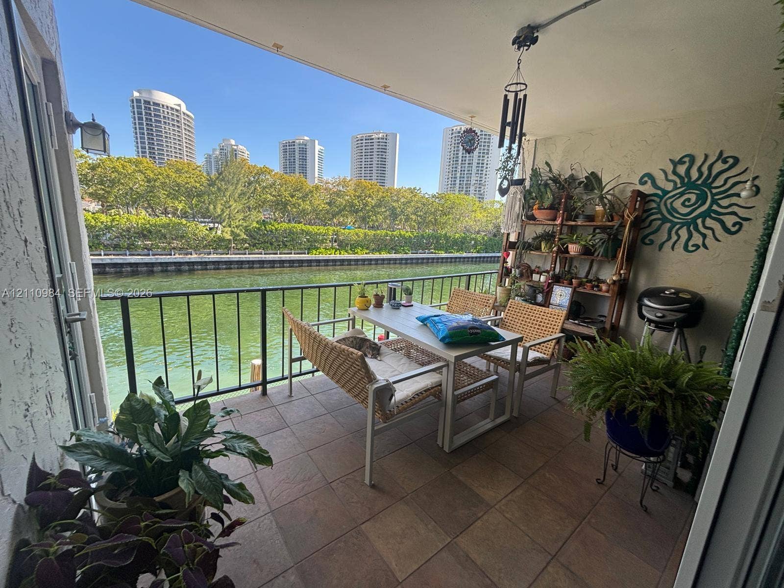 3745 NE 171st Street, #77, North Miami Beach, North Miami Beach, FL 33160 Covered balcony featuring tile flooring and a metal railing overlooking the waterway