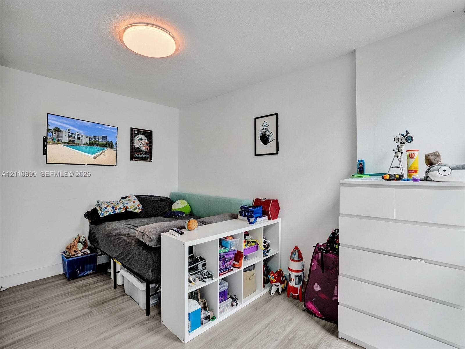 800 Parkview Drive, #131, Hallandale Beach, FL 33009 Room featuring neutral wall finishes, wood-finish flooring, and a circular flush-mount ceiling light