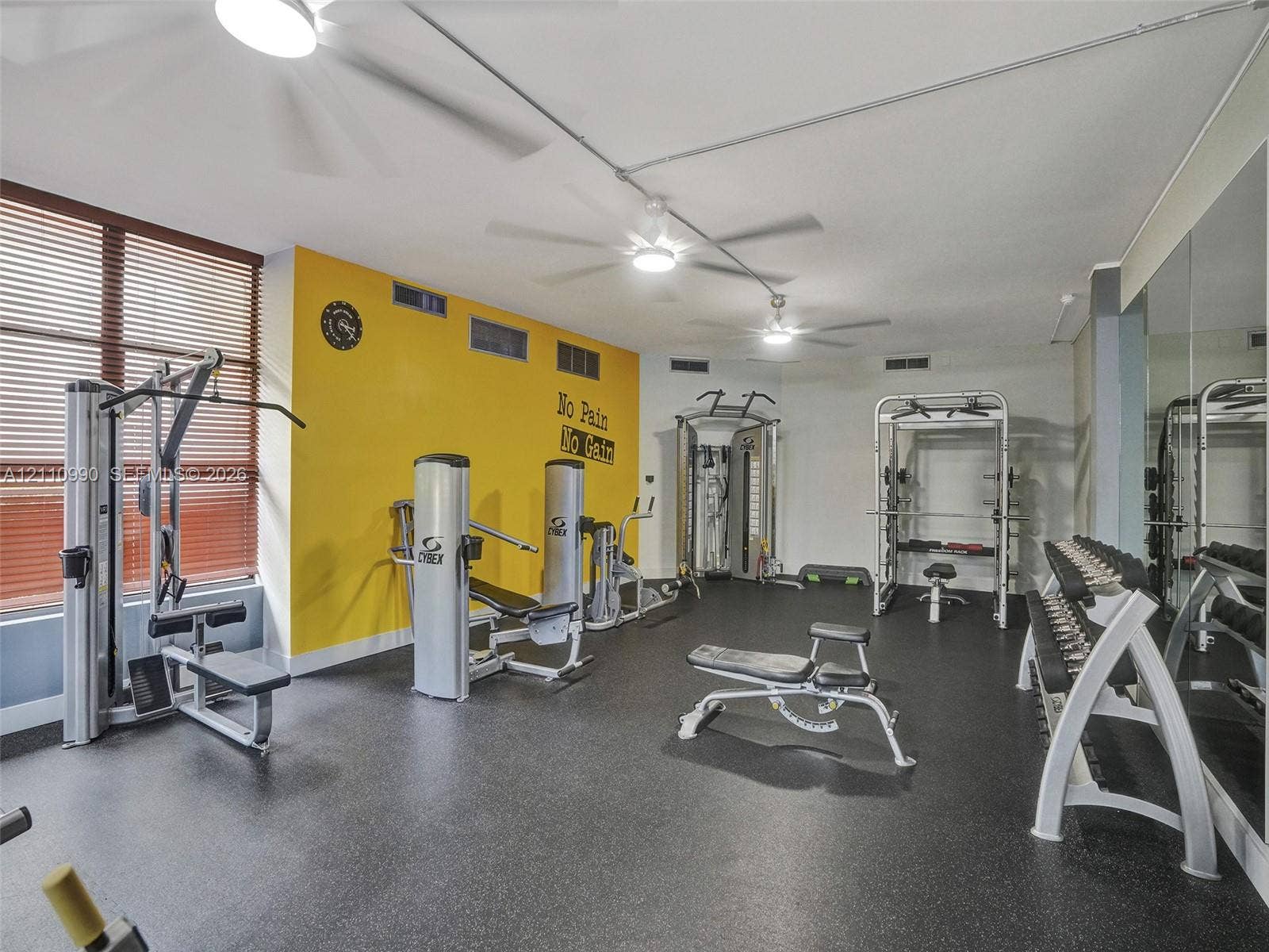 800 Parkview Drive, #131, Hallandale Beach, FL 33009 Fitness room featuring durable rubber flooring, mirrored walls, and multiple ceiling-mounted fans