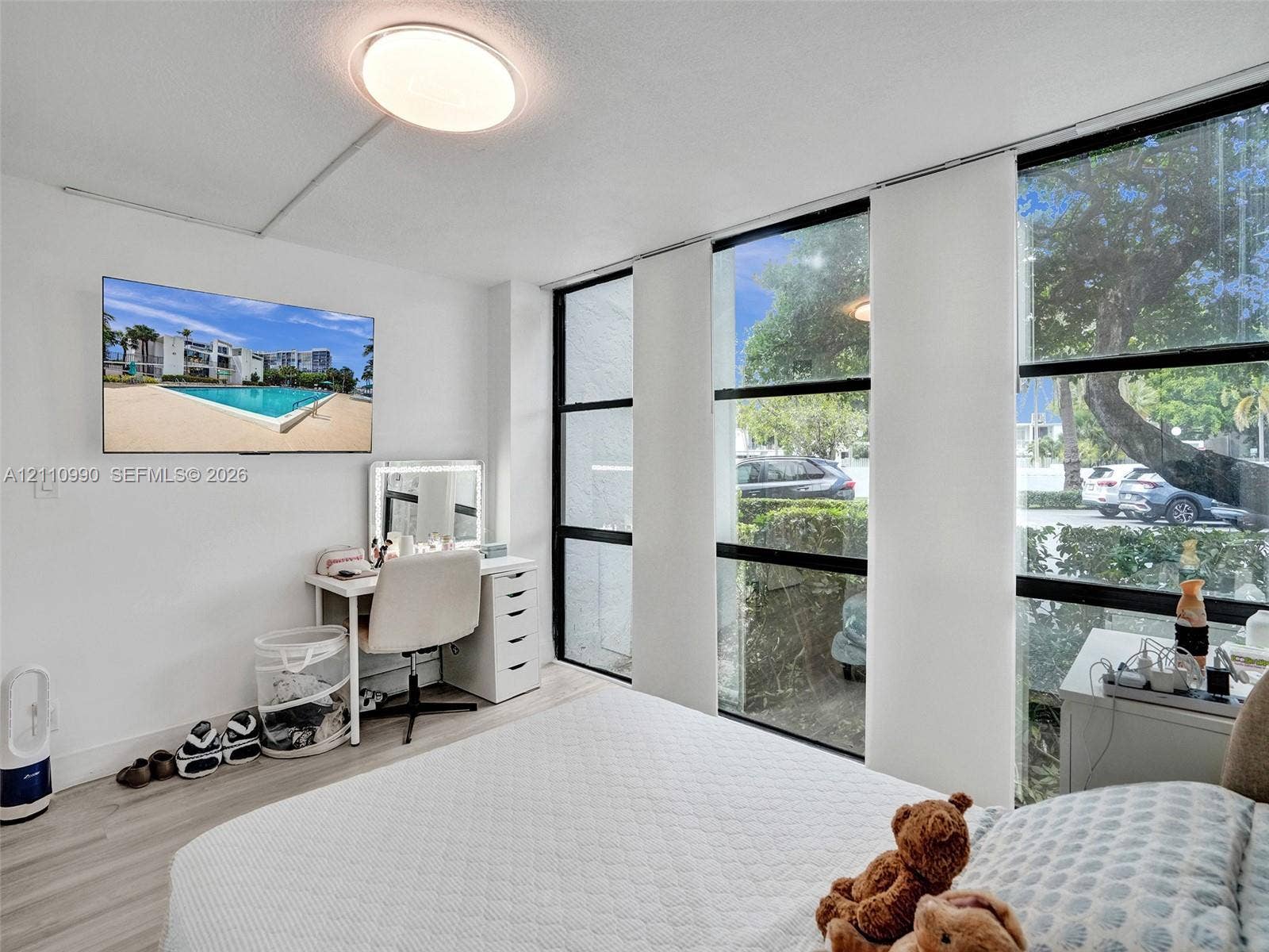 800 Parkview Drive, #131, Hallandale Beach, FL 33009 Floor-to-ceiling windows with black frames, wood-finish flooring, and flush-mount ceiling lighting