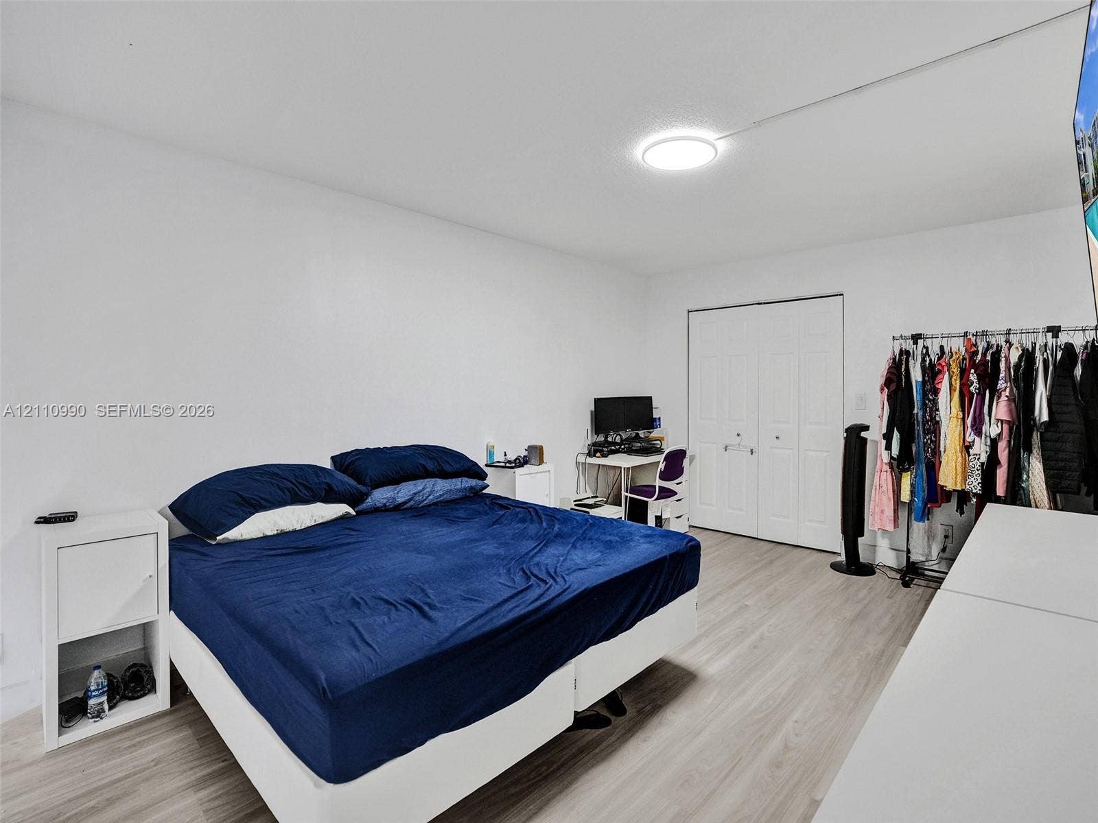 800 Parkview Drive, #131, Hallandale Beach, FL 33009 Wood-finish flooring, white walls, and a dual-panel closet door