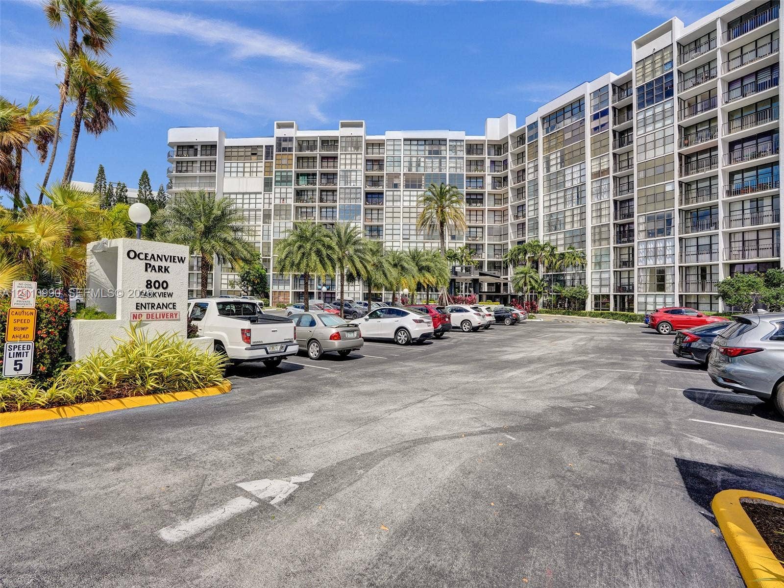 800 Parkview Drive, #131, Hallandale Beach, FL 33009 Multi-story residential complex featuring glass-paneled balconies and exterior signage