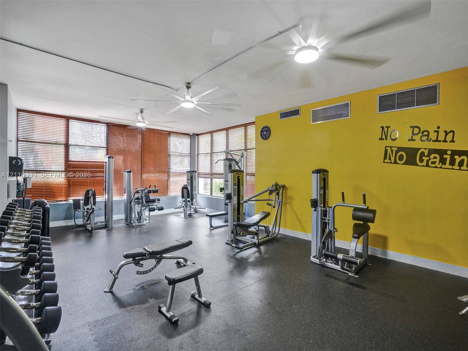 800 Parkview Drive, #131, Hallandale Beach, FL 33009 Fitness space featuring rubberized flooring, expansive windows with integrated blinds, and multiple ceiling-mounted light fixtures