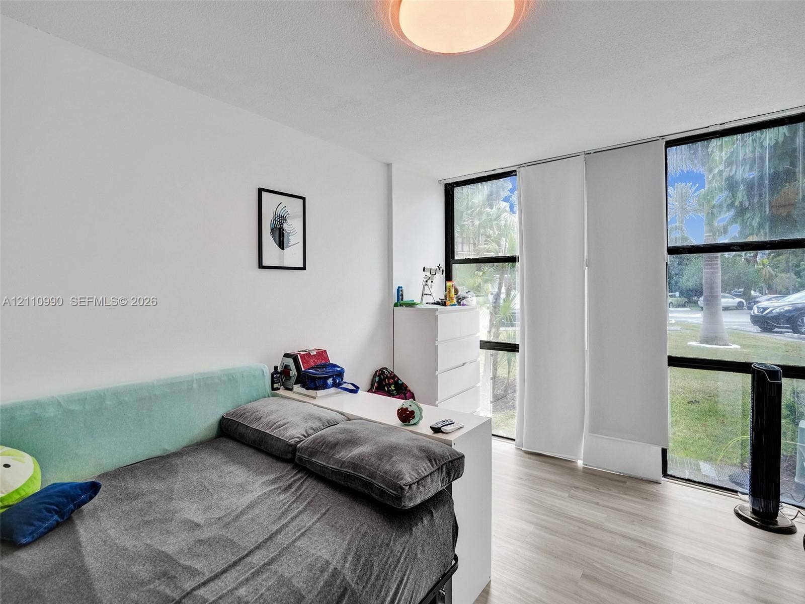 800 Parkview Drive, #131, Hallandale Beach, FL 33009 Floor-to-ceiling windows featuring black framing and light-toned wood-finish flooring