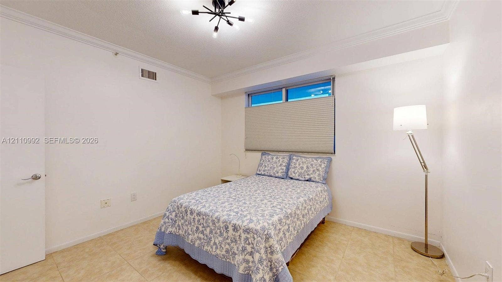 Neutral interior featuring tile flooring, crown molding, and a multi-arm geometric ceiling fixture