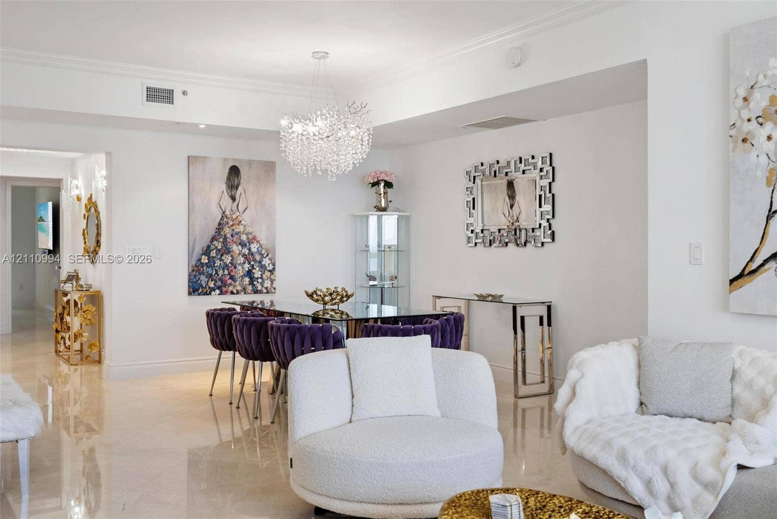 17875 Collins Avenue, #2405, Sunny Isles Beach, Sunny Isles Beach, FL 33160 Polished stone flooring, intricate crystal statement chandelier, crown molding, and recessed wall niche