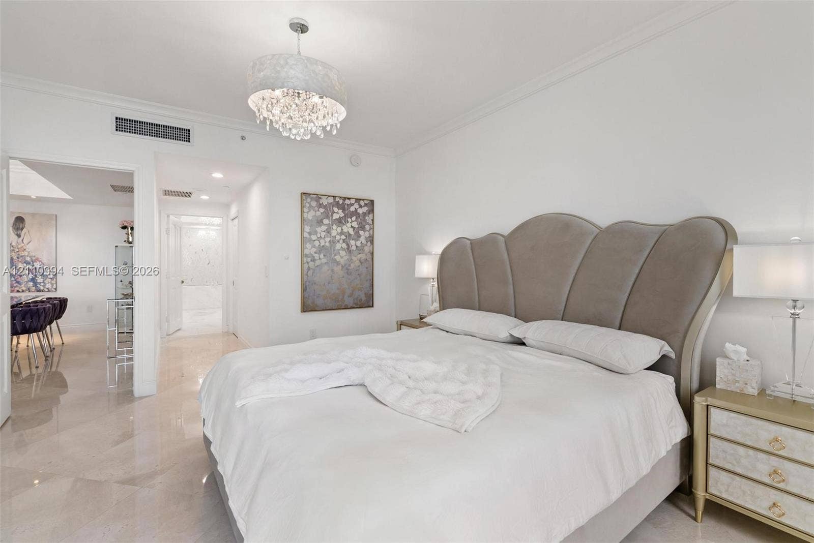 17875 Collins Avenue, #2405, Sunny Isles Beach, Sunny Isles Beach, FL 33160 Polished stone flooring, crown molding, and crystal-accented drum pendant lighting