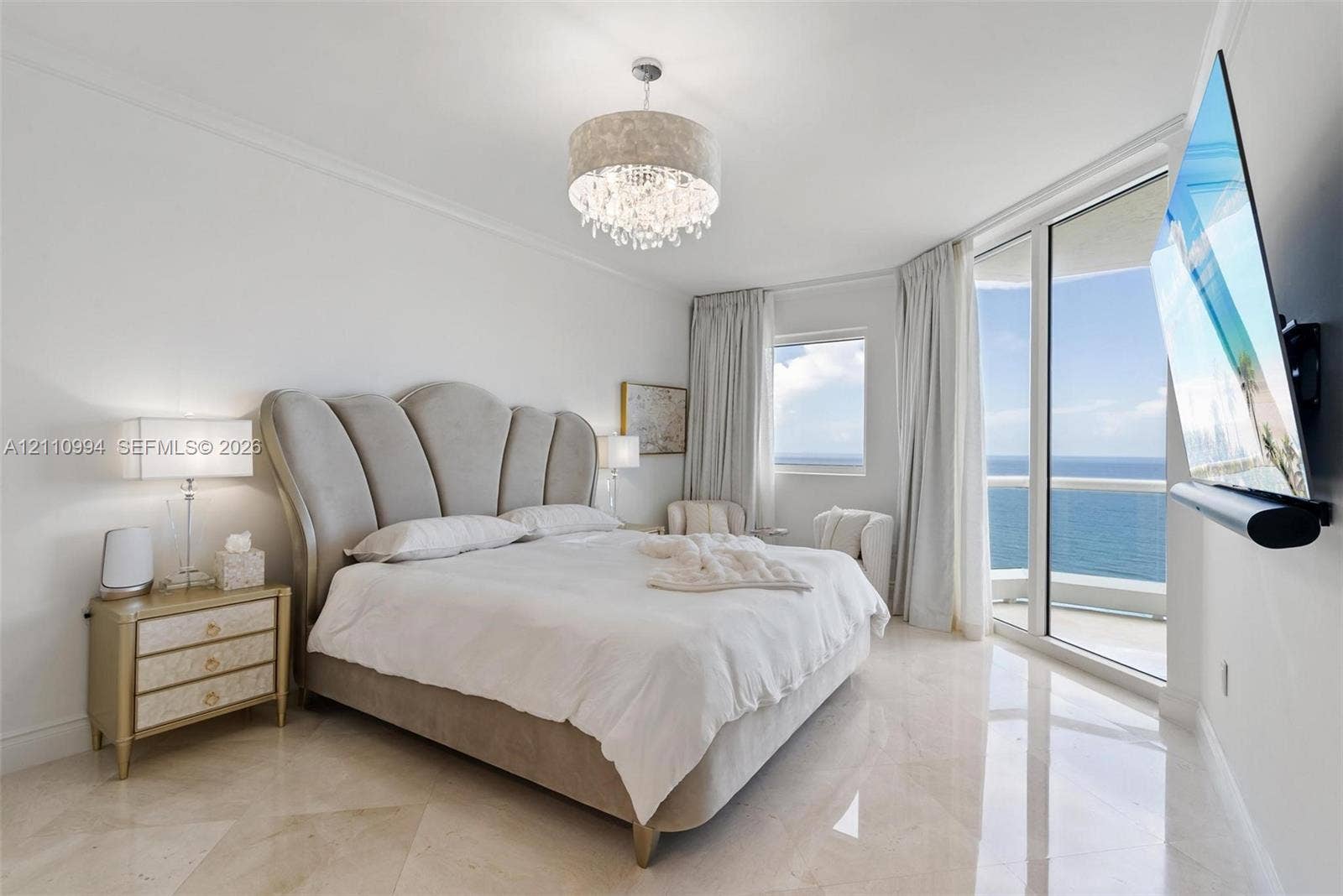 17875 Collins Avenue, #2405, Sunny Isles Beach, Sunny Isles Beach, FL 33160 Polished tile flooring, floor-to-ceiling glass paneling, balcony access, and an ornate drum-style chandelier