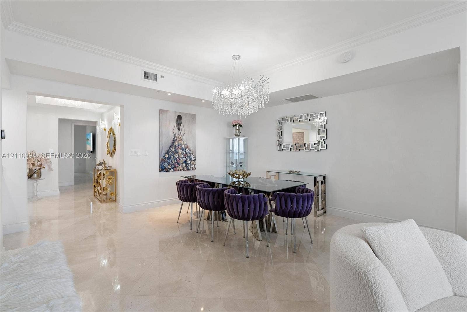 17875 Collins Avenue, #2405, Sunny Isles Beach, Sunny Isles Beach, FL 33160 Polished stone flooring, crown molding, and a tiered crystal chandelier