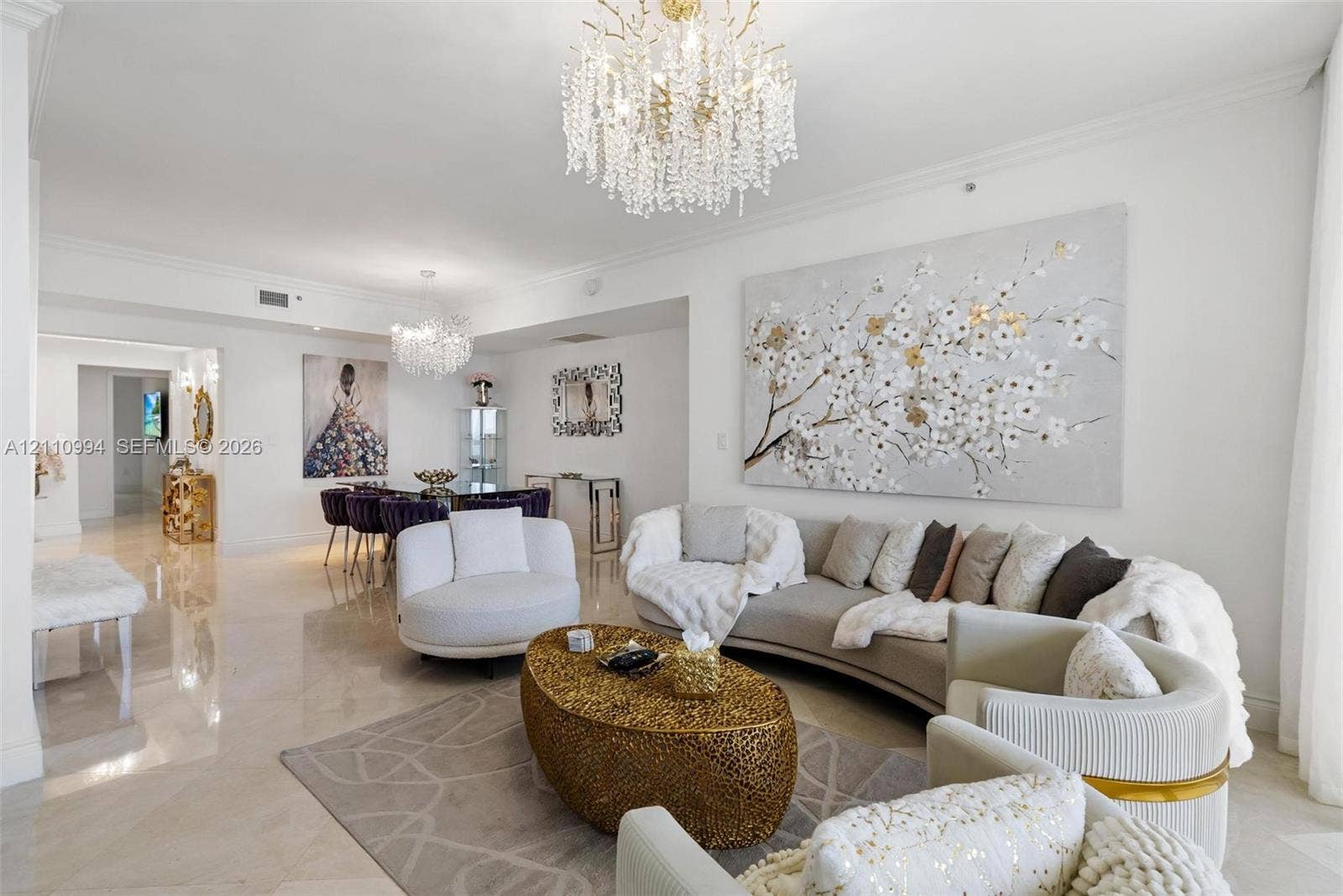 17875 Collins Avenue, #2405, Sunny Isles Beach, Sunny Isles Beach, FL 33160 Open-concept interior featuring large-format polished stone flooring, crown molding, and dual ornate crystal chandeliers