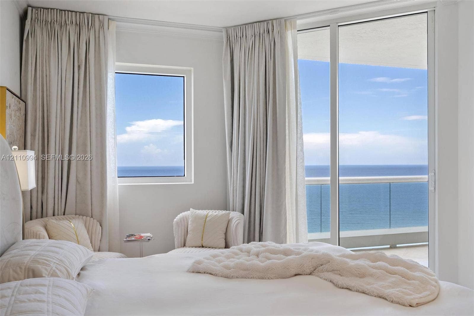 17875 Collins Avenue, #2405, Sunny Isles Beach, Sunny Isles Beach, FL 33160 Floor-to-ceiling windows, sliding glass door with glass railing balcony, and ocean horizon backdrop