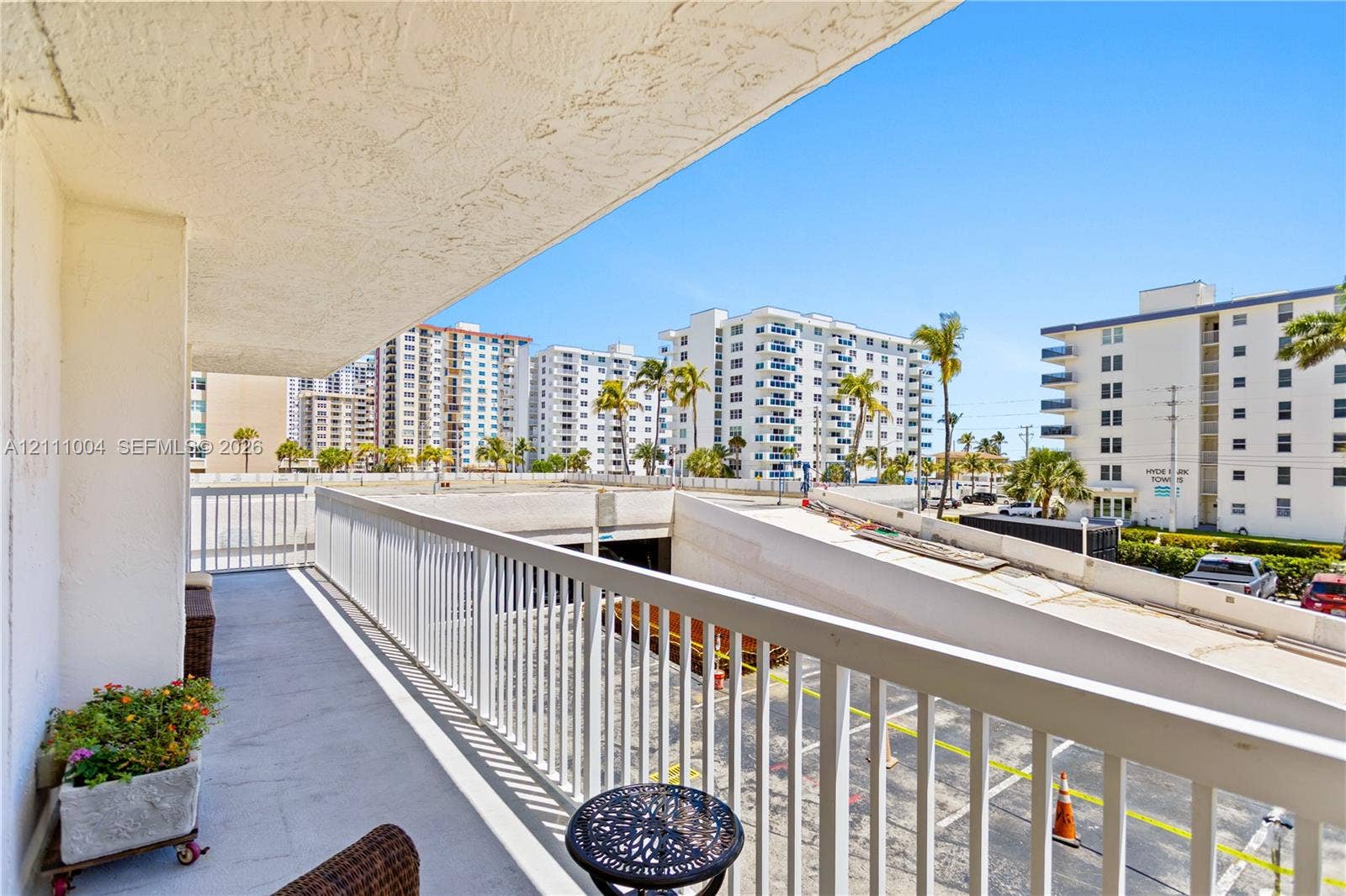 Private balcony featuring a concrete surface and white metal railing