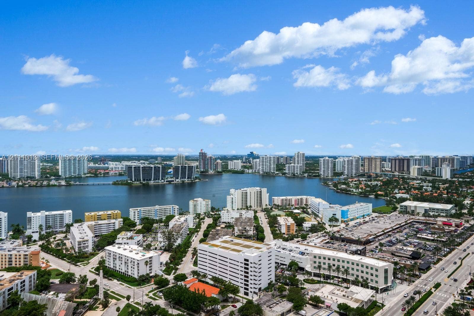 Aerial perspective featuring a panoramic expanse of waterfront and urban landscape