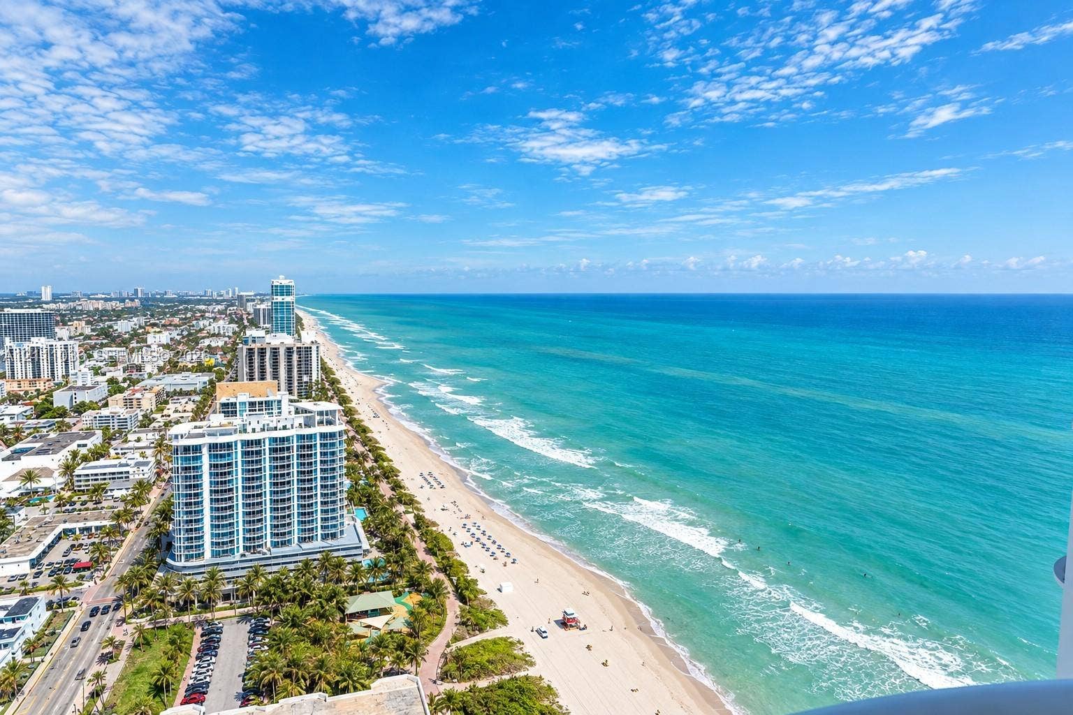 6365 Collins Avenue, #3811, Miami Beach, FL 33141 Aerial perspective of the coastline featuring expansive ocean frontage, sandy beaches, and high-rise structural density