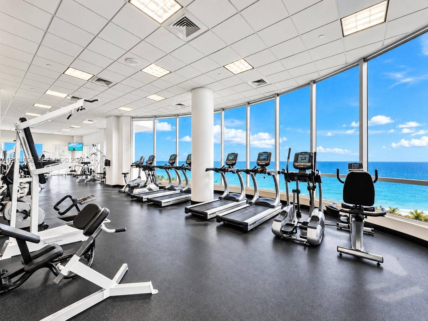 6365 Collins Avenue, #3811, Miami Beach, FL 33141 Fitness center featuring floor-to-ceiling windows, panoramic ocean scenery, recessed lighting, and rubberized flooring