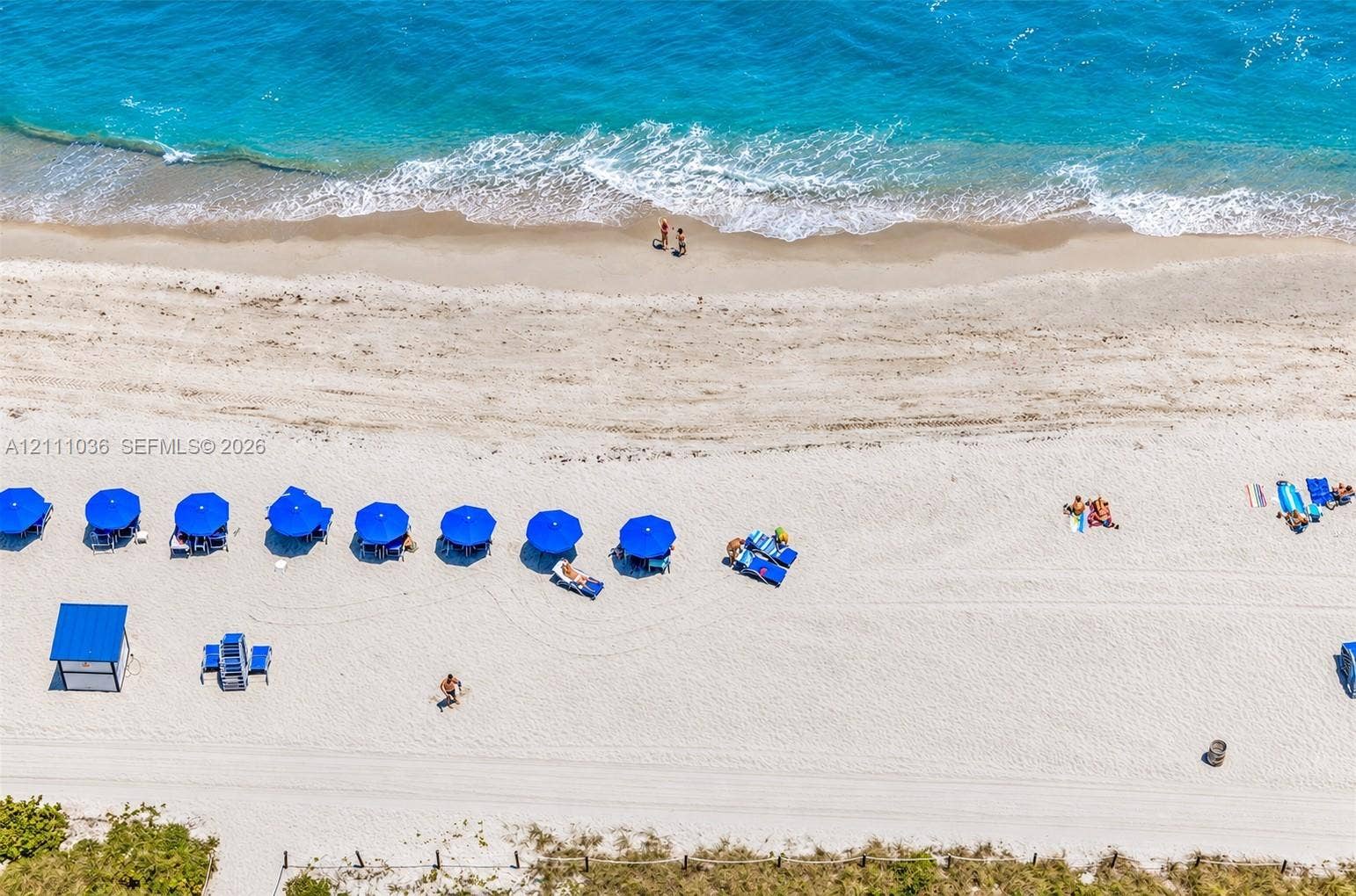 6365 Collins Avenue, #3811, Miami Beach, FL 33141 Direct oceanfront access featuring expansive sandy shoreline, turquoise water, and professional hardscaping