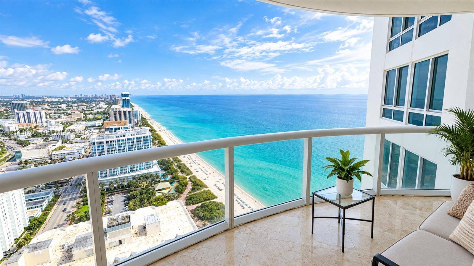 6365 Collins Avenue, #3811, Miami Beach, FL 33141 Private balcony featuring polished stone flooring and glass panel railings with an unobstructed coastal panorama