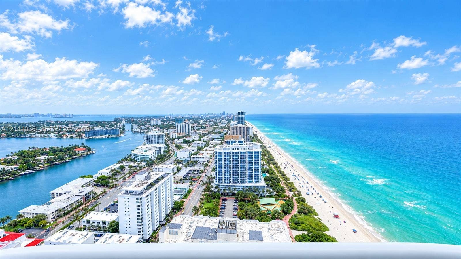 6365 Collins Avenue, #3811, Miami Beach, FL 33141 High-rise aerial perspective capturing coastal shoreline, expansive ocean horizon, and inland waterway