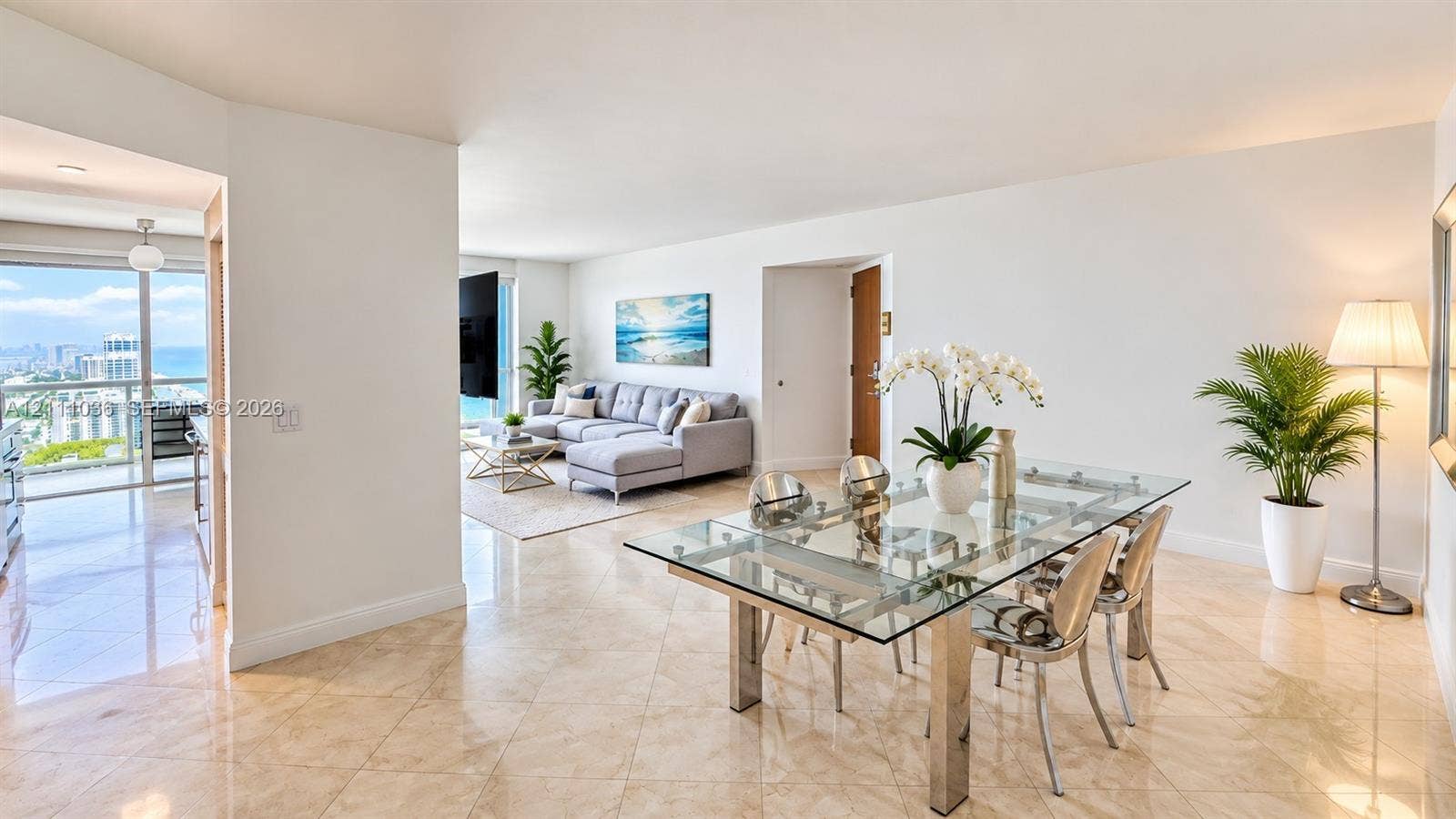 6365 Collins Avenue, #3811, Miami Beach, FL 33141 Open-concept living space featuring polished tile flooring, floor-to-ceiling glass sliding doors, and a private balcony
