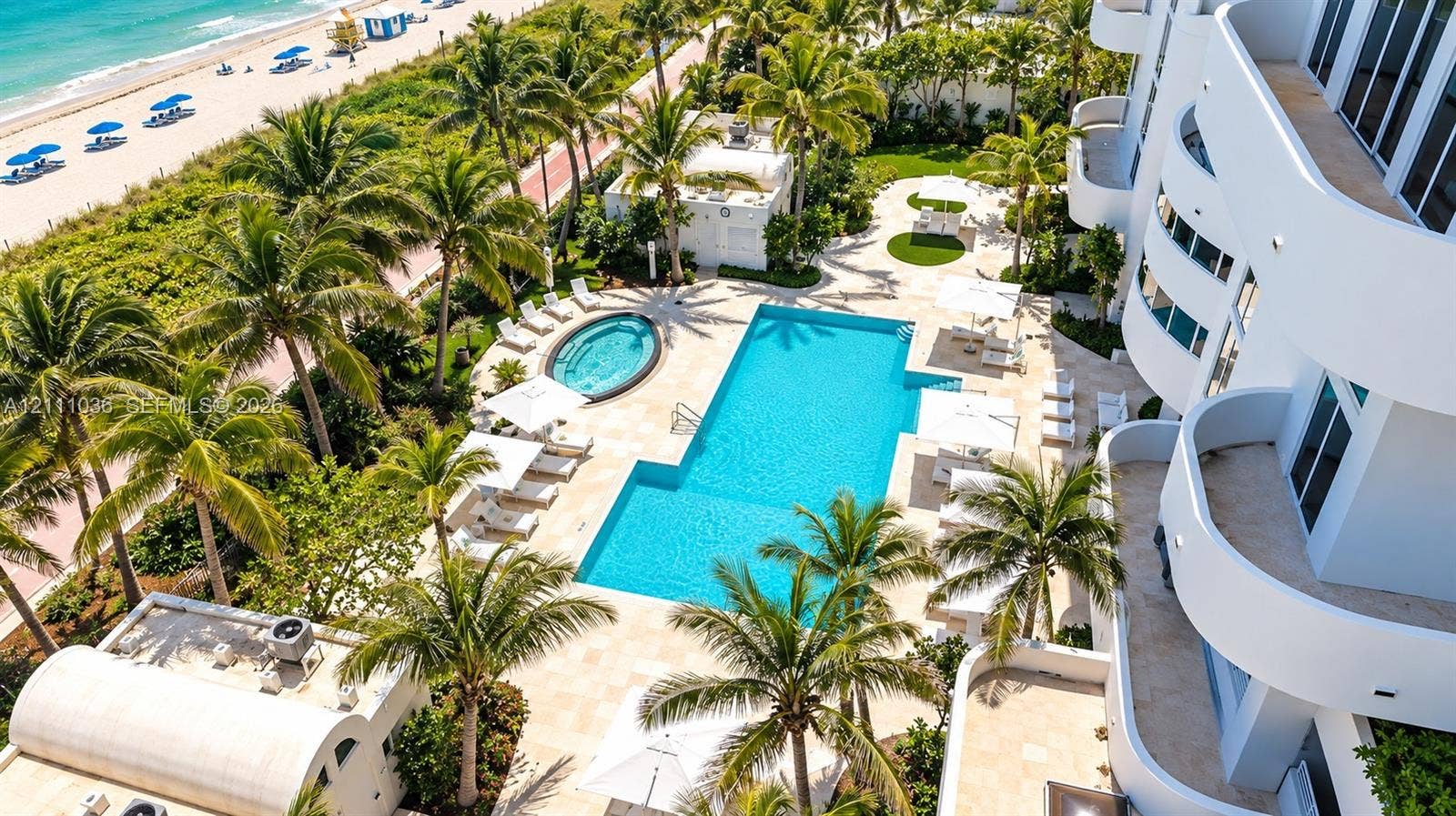 6365 Collins Avenue, #3811, Miami Beach, FL 33141 Oceanfront swimming pool and spa surrounded by stone decking, mature palm trees, and multi-level curved balconies