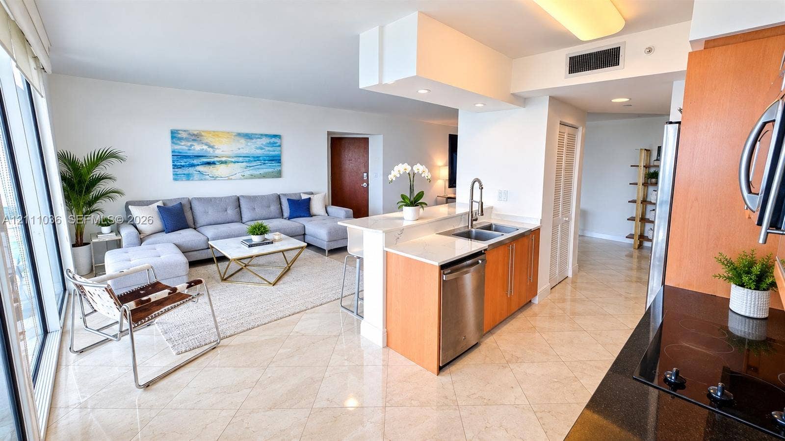 6365 Collins Avenue, #3811, Miami Beach, FL 33141 Kitchen featuring light-finish cabinetry, stone-surface countertops, dual-basin stainless steel sink with pull-down faucet, stainless steel dishwasher, and polished tile flooring